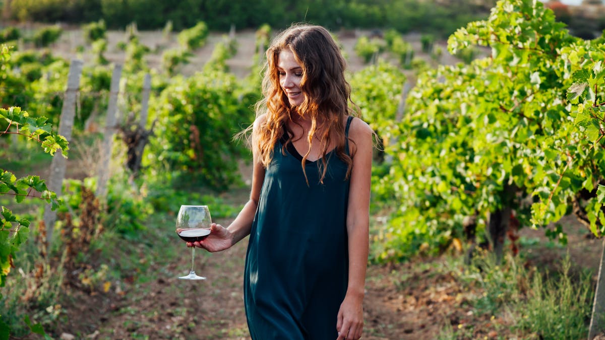 Enjoying a glass of wine strolling in the vineyard