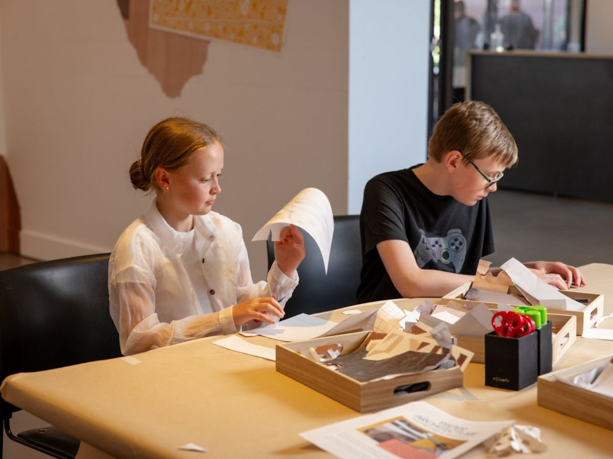 Children and teenagers create collages with paper and other art materials