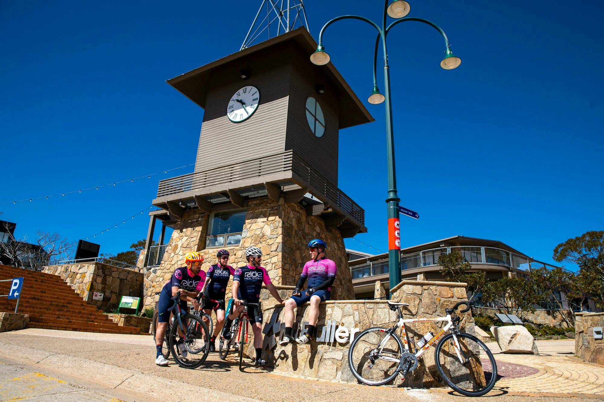 Group of cyclists celebrating conquering the Mt Buller road climb