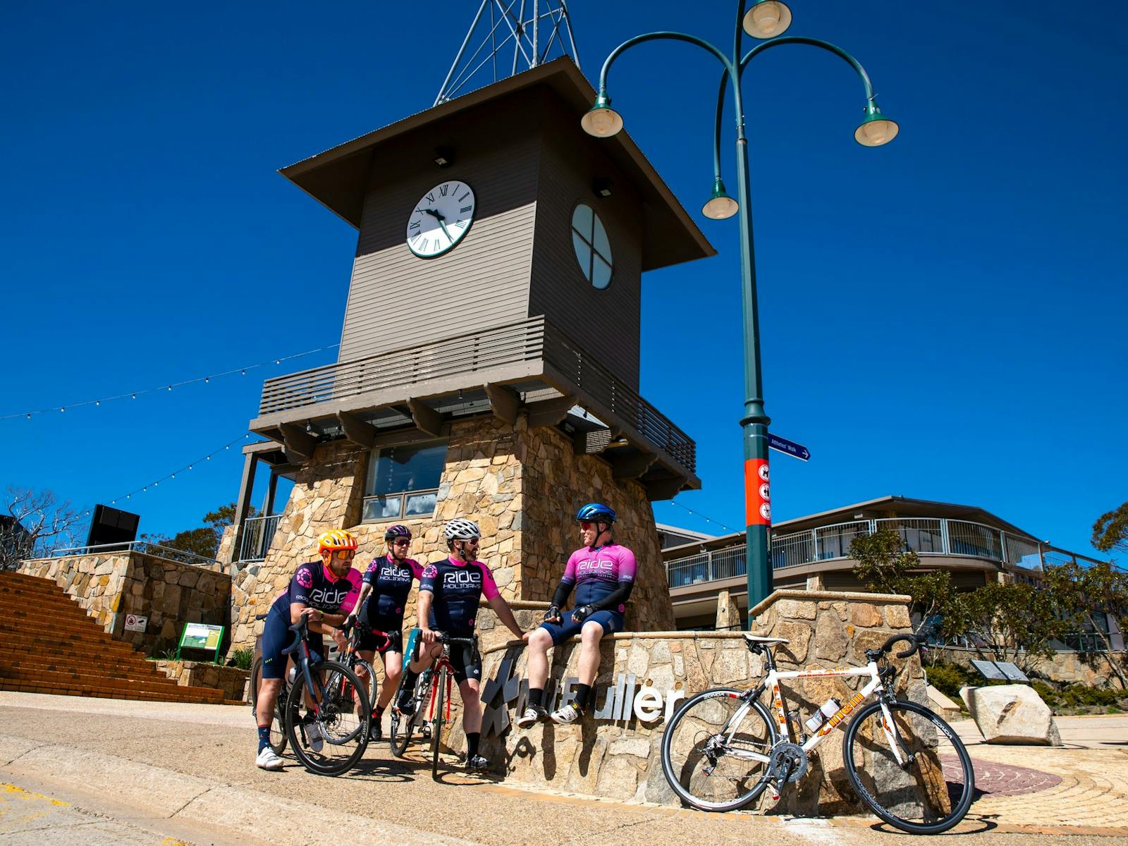 Group of cyclists celebrating conquering the Mt Buller road climb