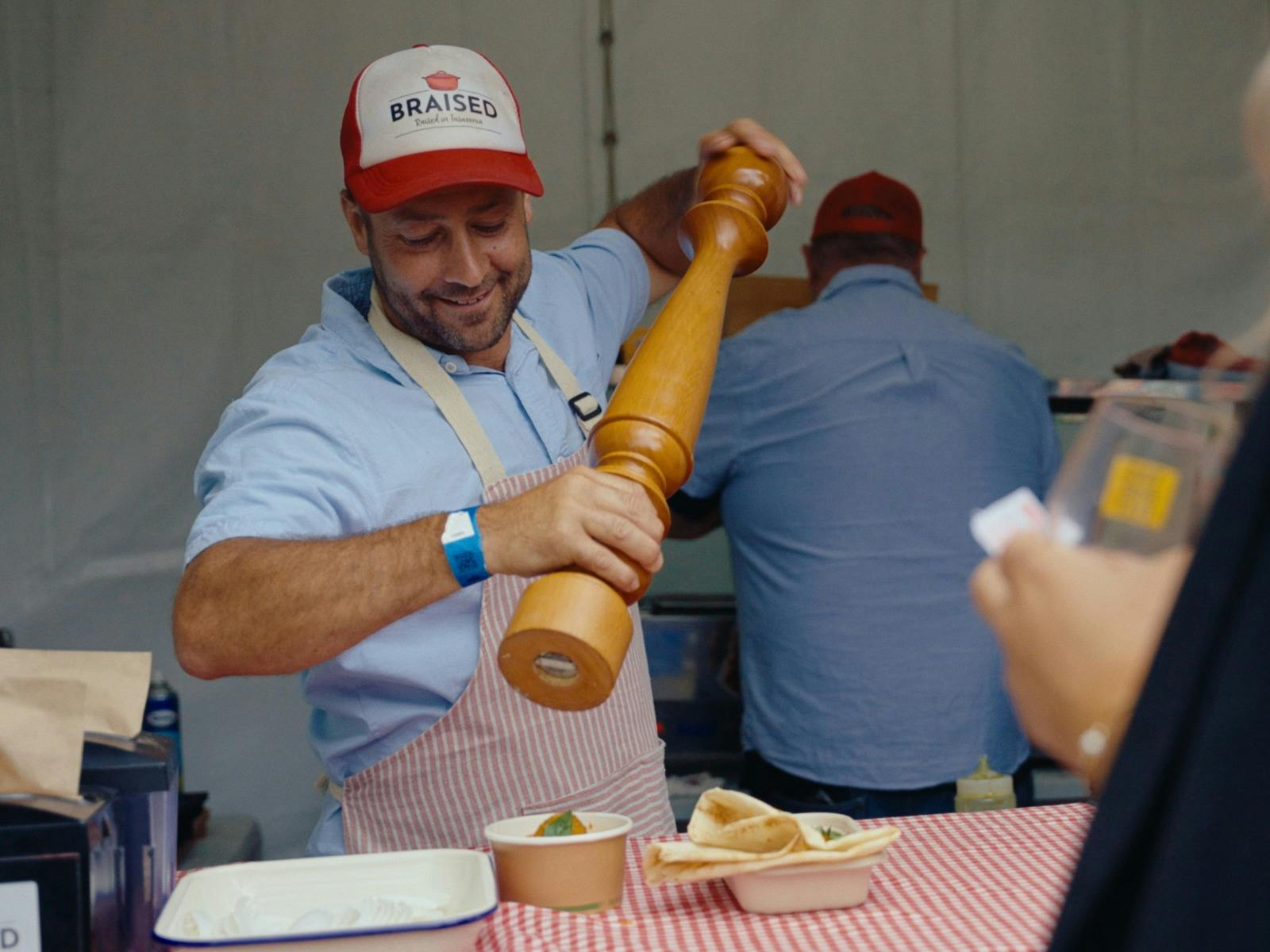 Image of a food vendor with an oversized pepper grinder at the Tasmanian Wine Festival