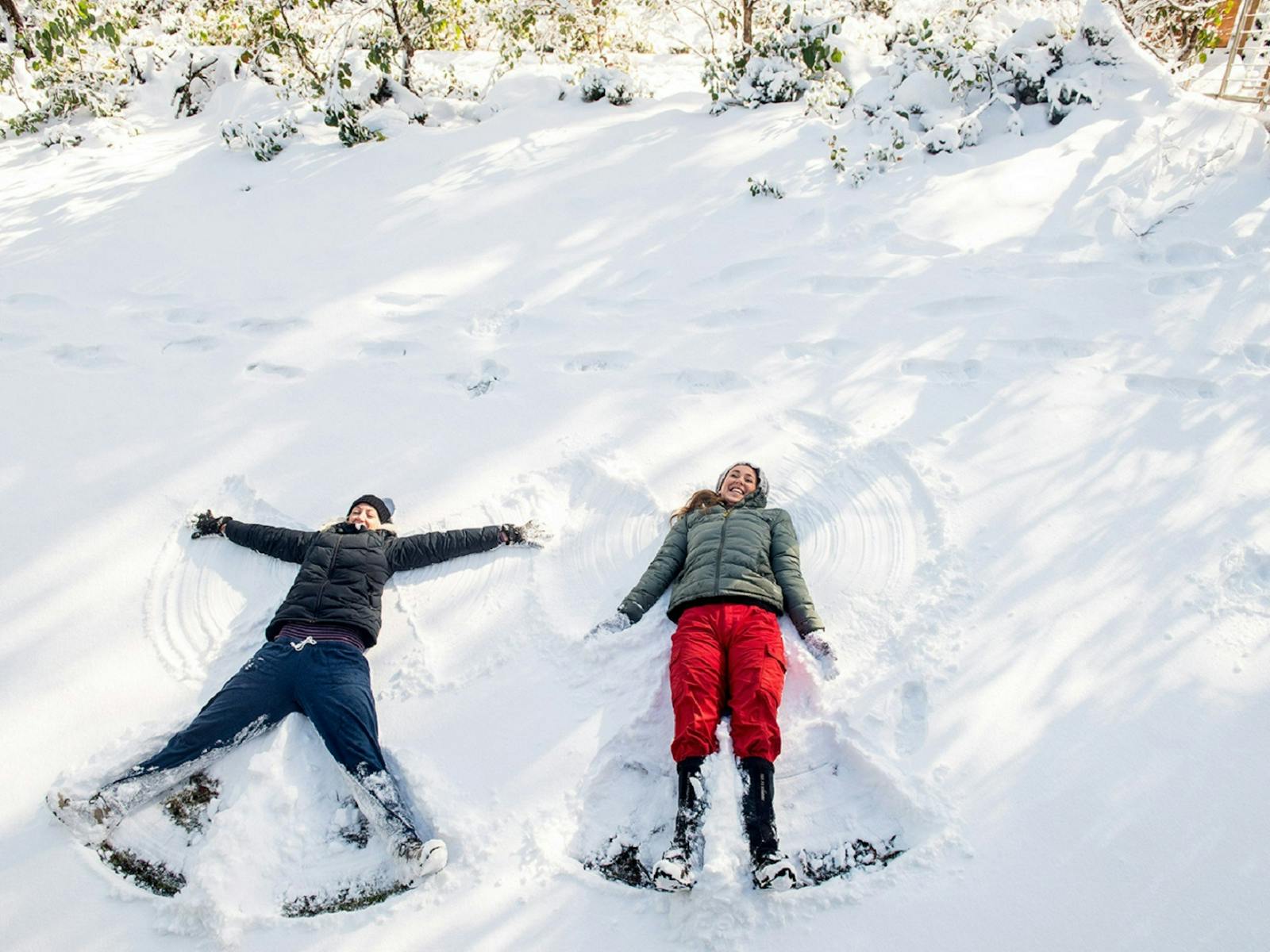 Two women smiling and making snow angels