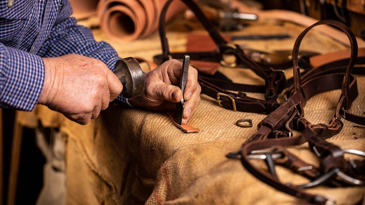 Close up of artisan carrying out leather-work
