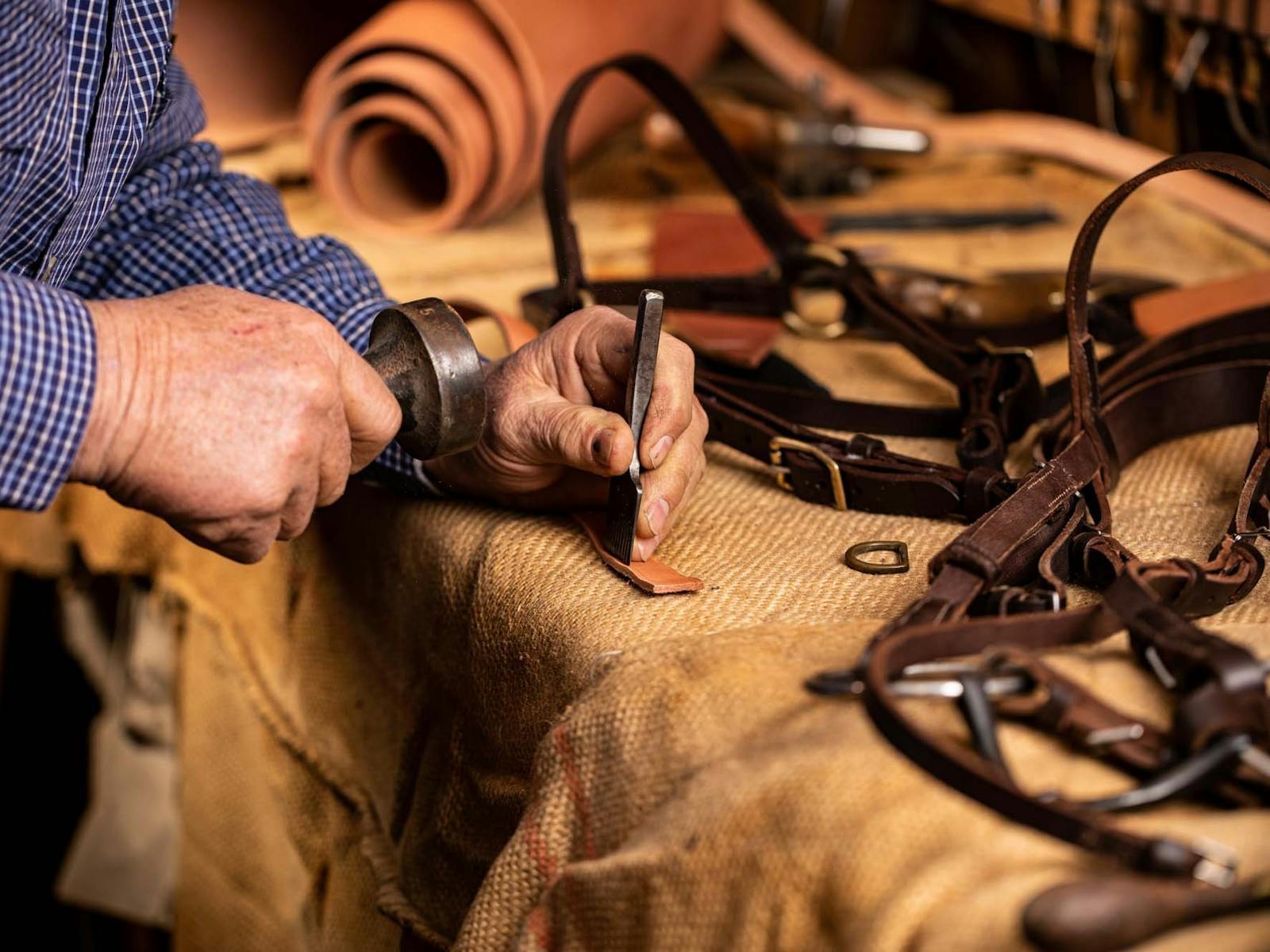Close up of artisan carrying out leather-work Close up of artisan carrying out leather-work
