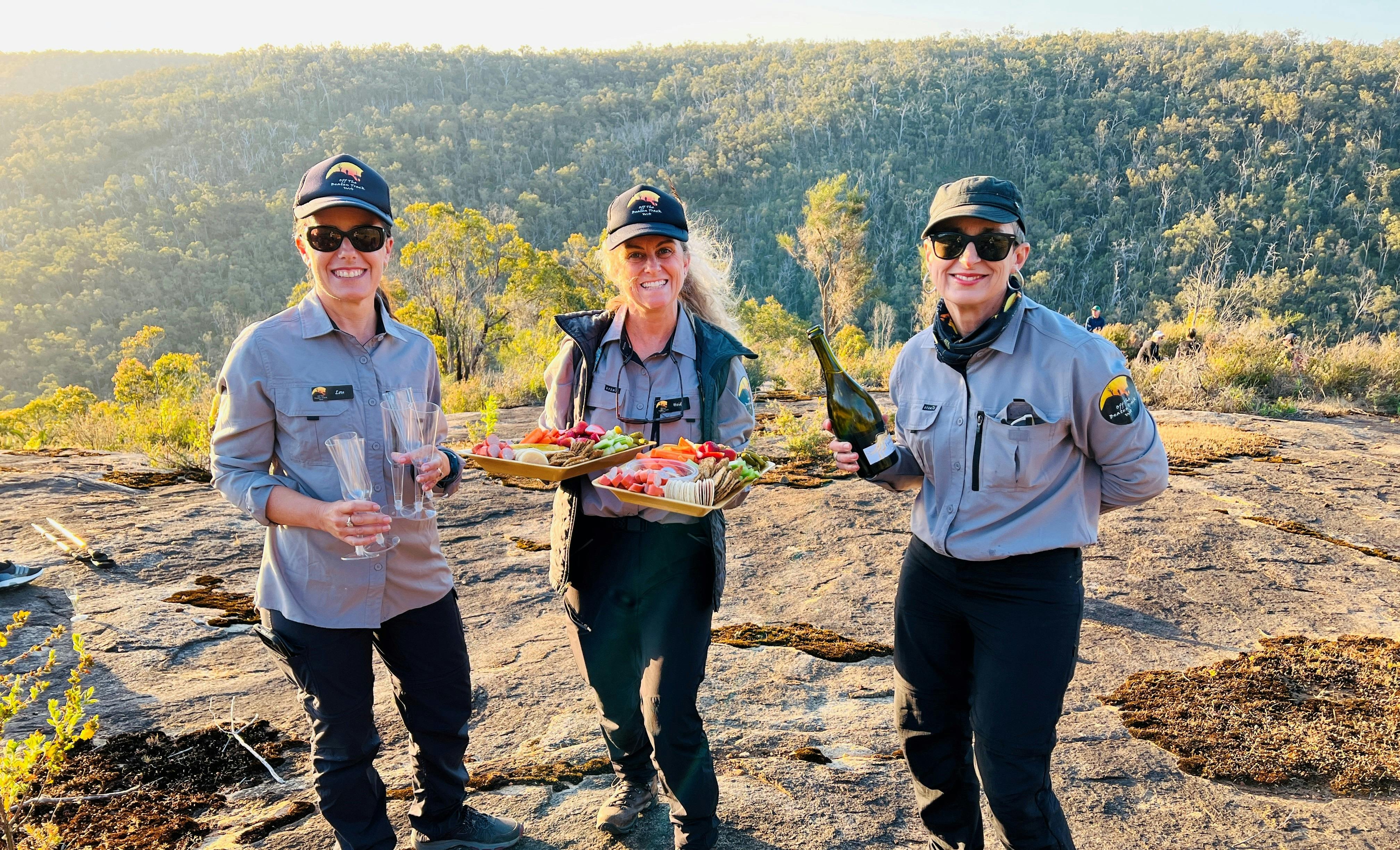 3 Friendly OTBT Guides holding gourmet nibble platter