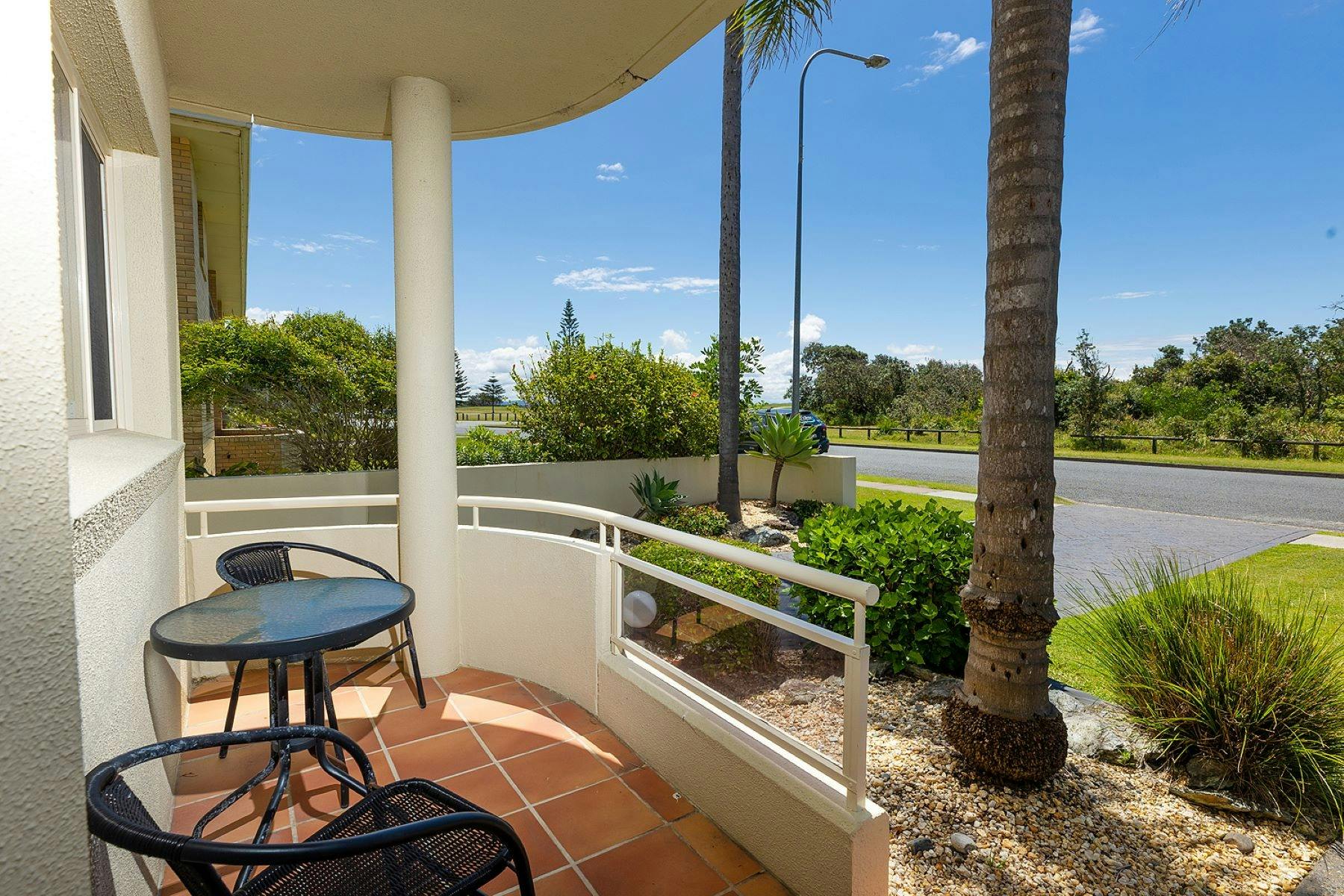 Patio with 2 seater setting and views across to beach and reserve