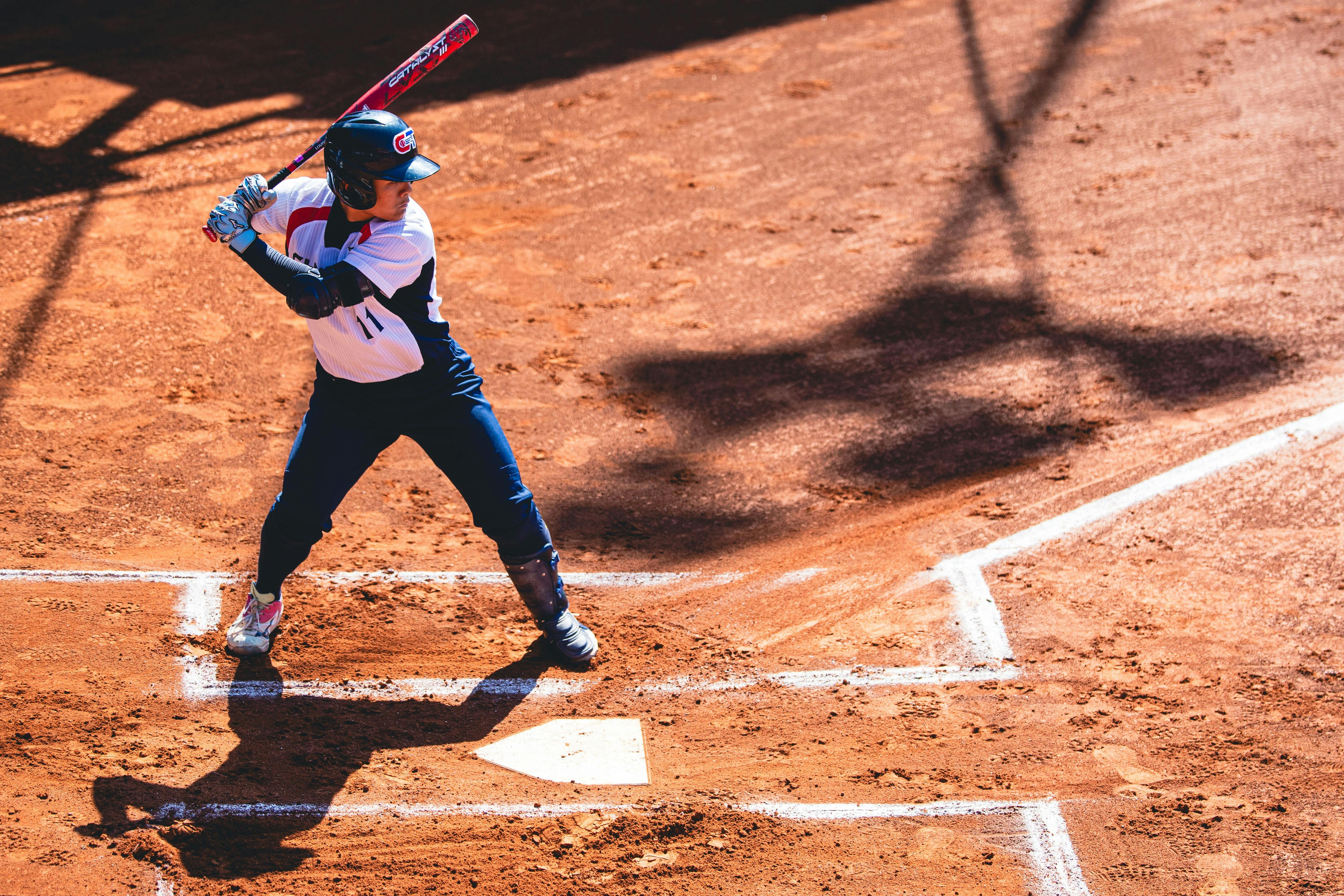 Softball player slides into home plate through dust as catcher waits during competitive match.  Prov