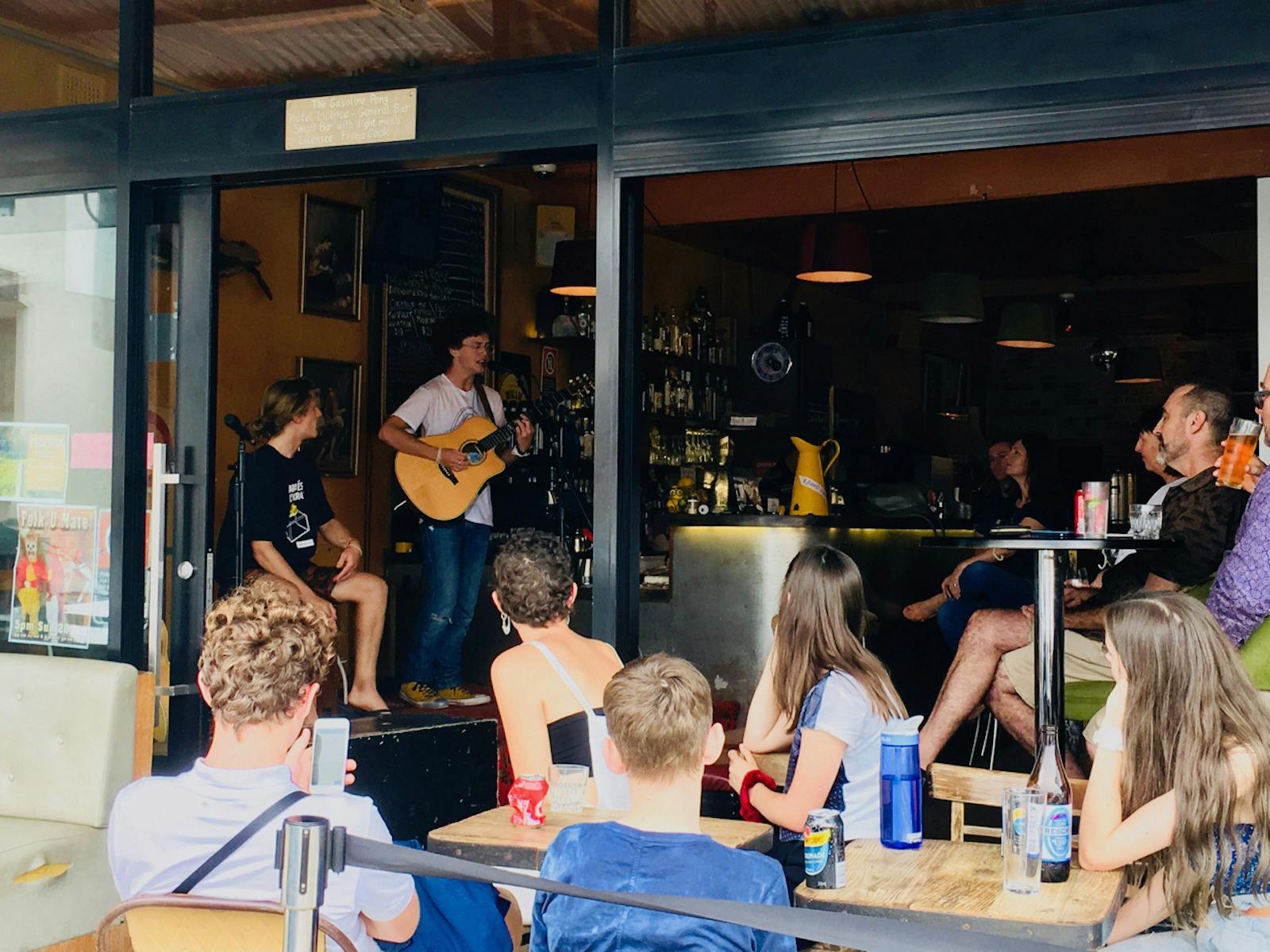 ID shows a group of happy people at the Gasoline Pony listening to a band perform