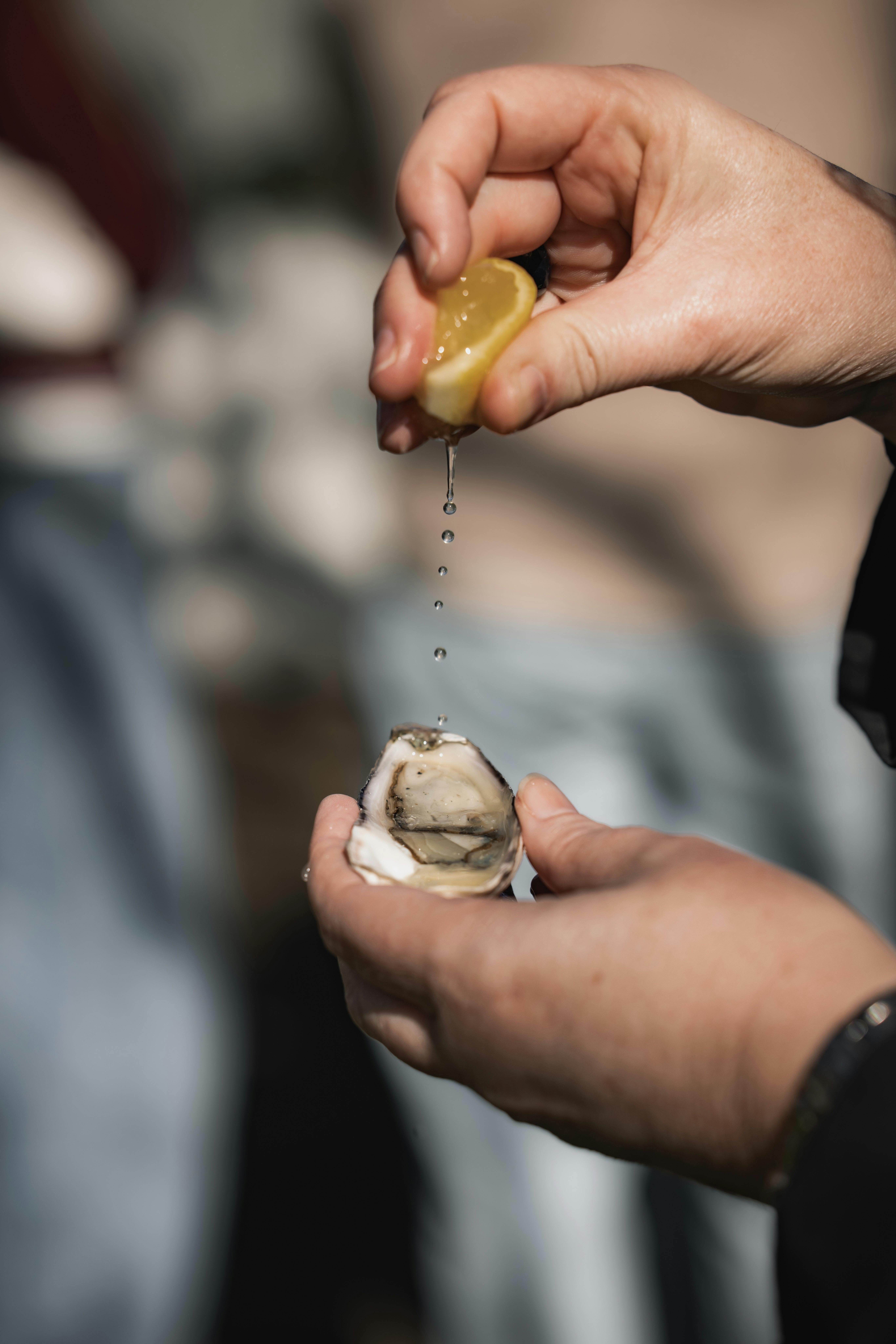 Squeezing lemon on an oyster