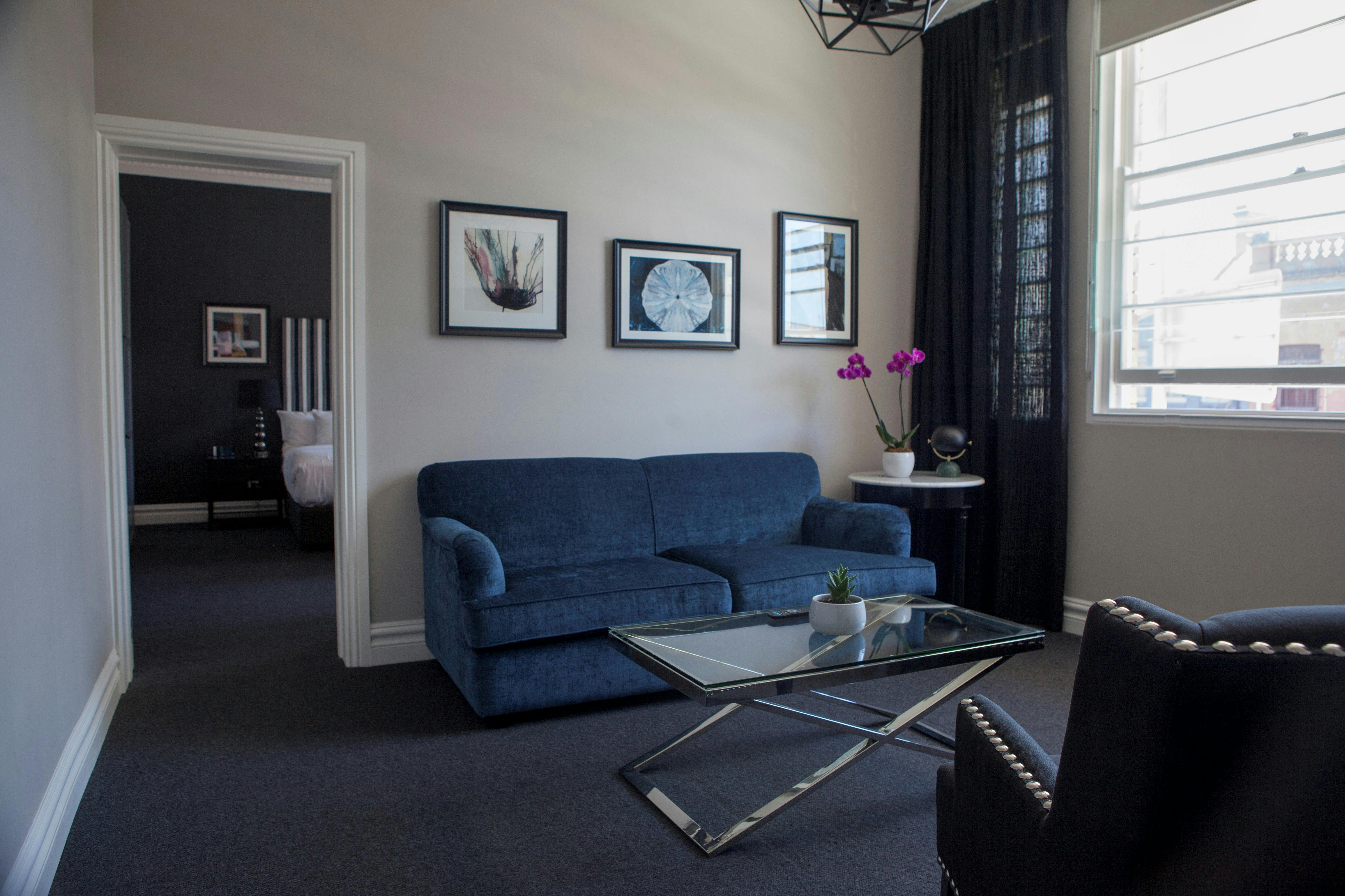 Grand Heritage Suite showing sitting room with bedroom in background.