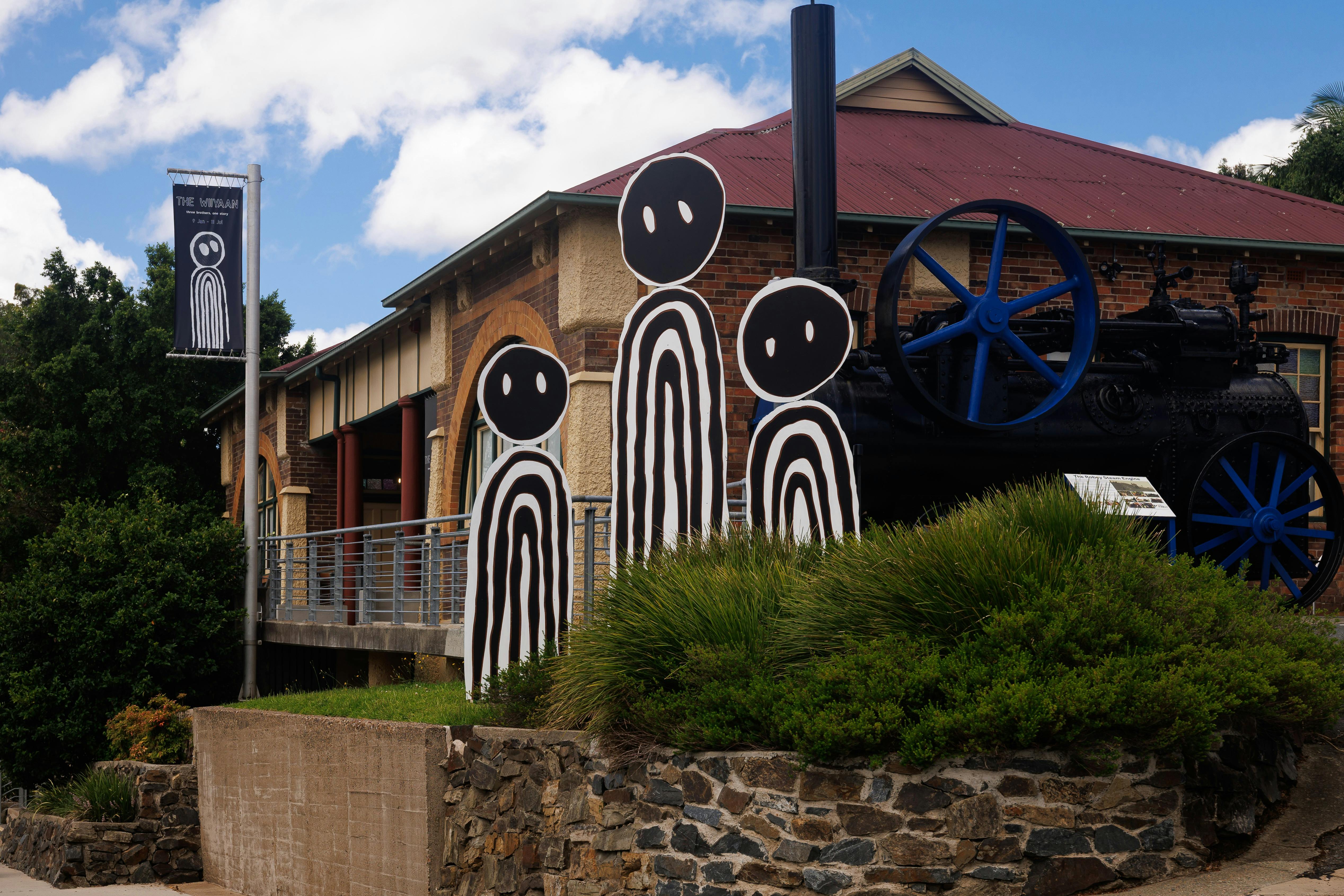 Front of the Tweed Regional Museum building featuring a steam engine