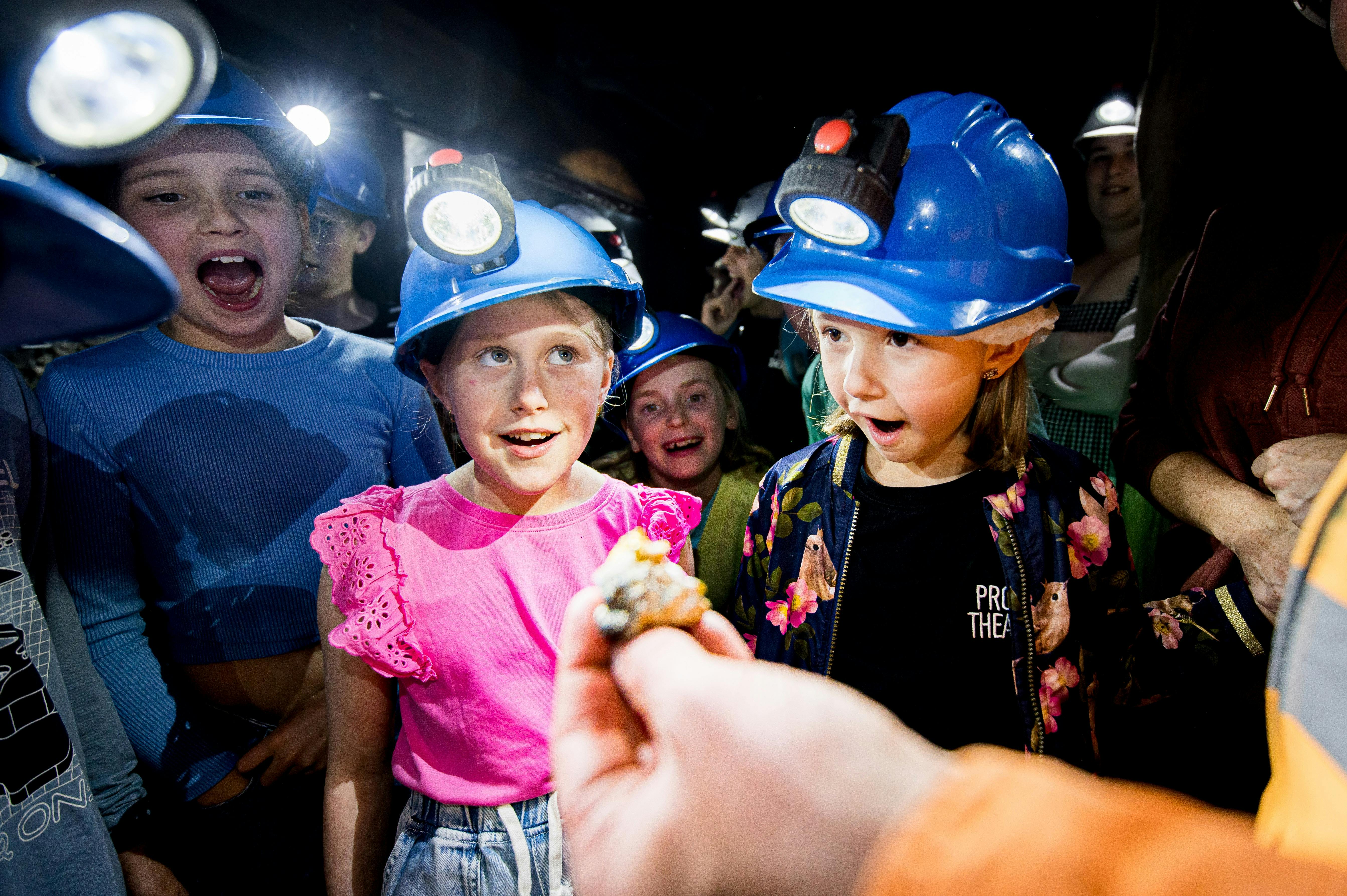 Kids looking at a gold nugget