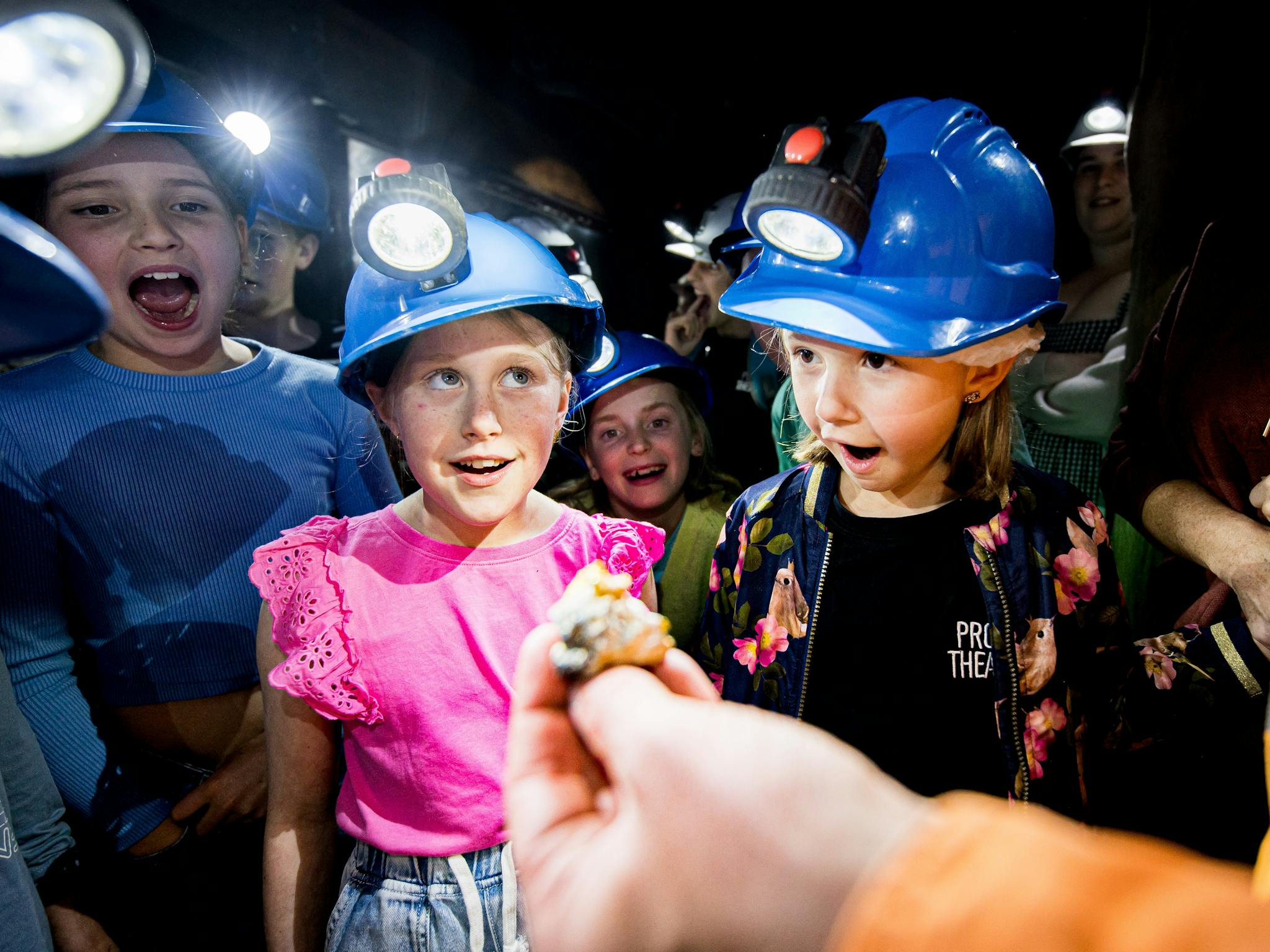 Kids looking at a gold nugget