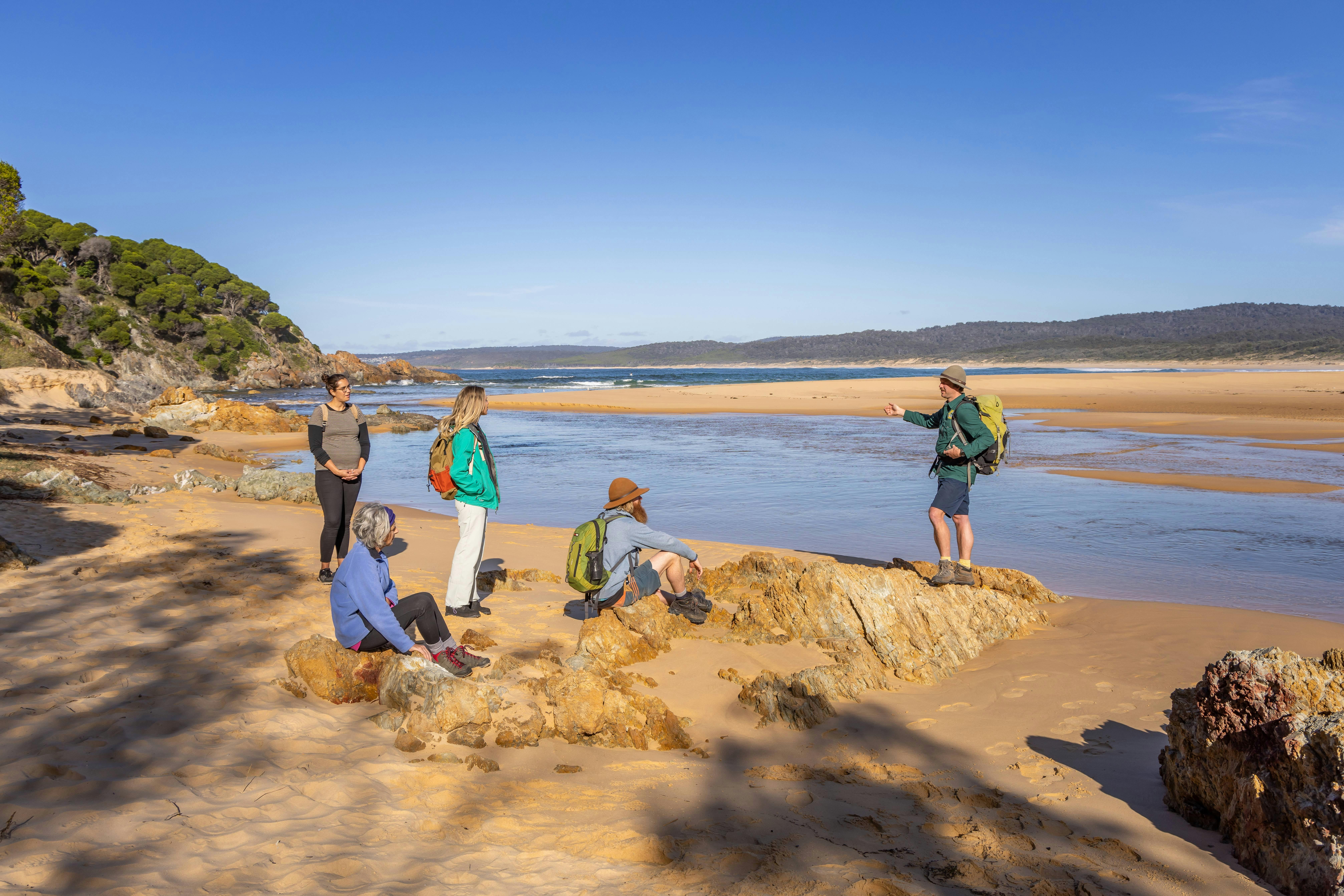 Guide talking to walkers on the Wharf to Wharf walk on the Sapphire Coast on NSW