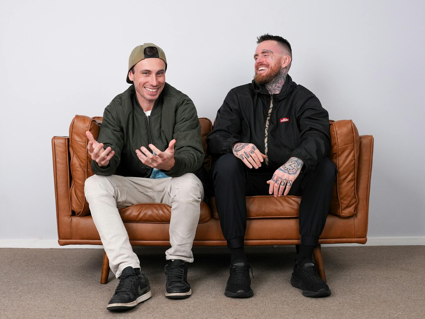 the rapper pez and 360 sitting together on a couch