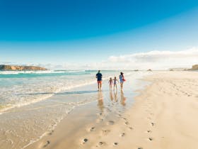 A family walk along the Almonta Beach shoreline