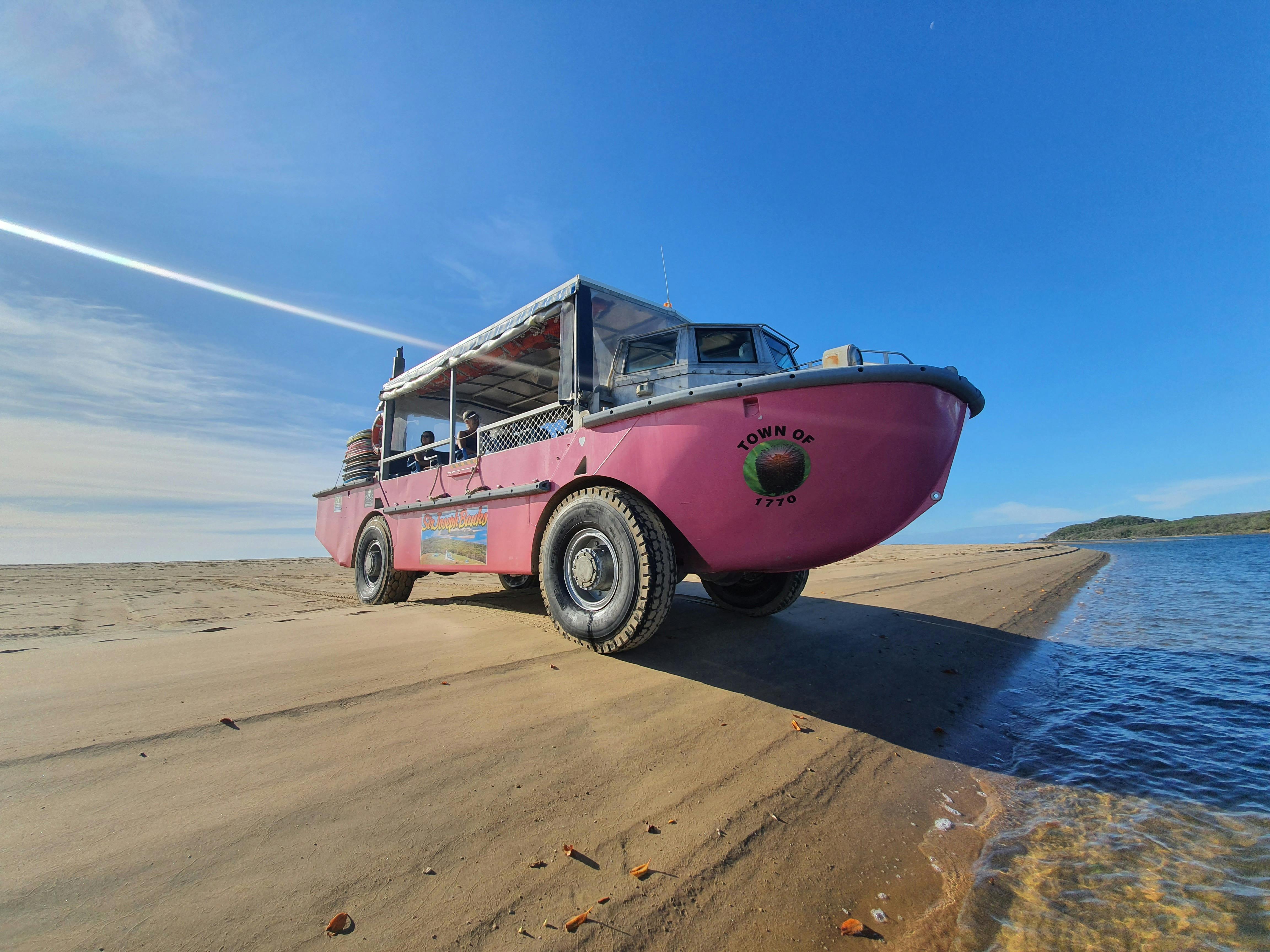 Amphibious vessel on a sand bank in front of water