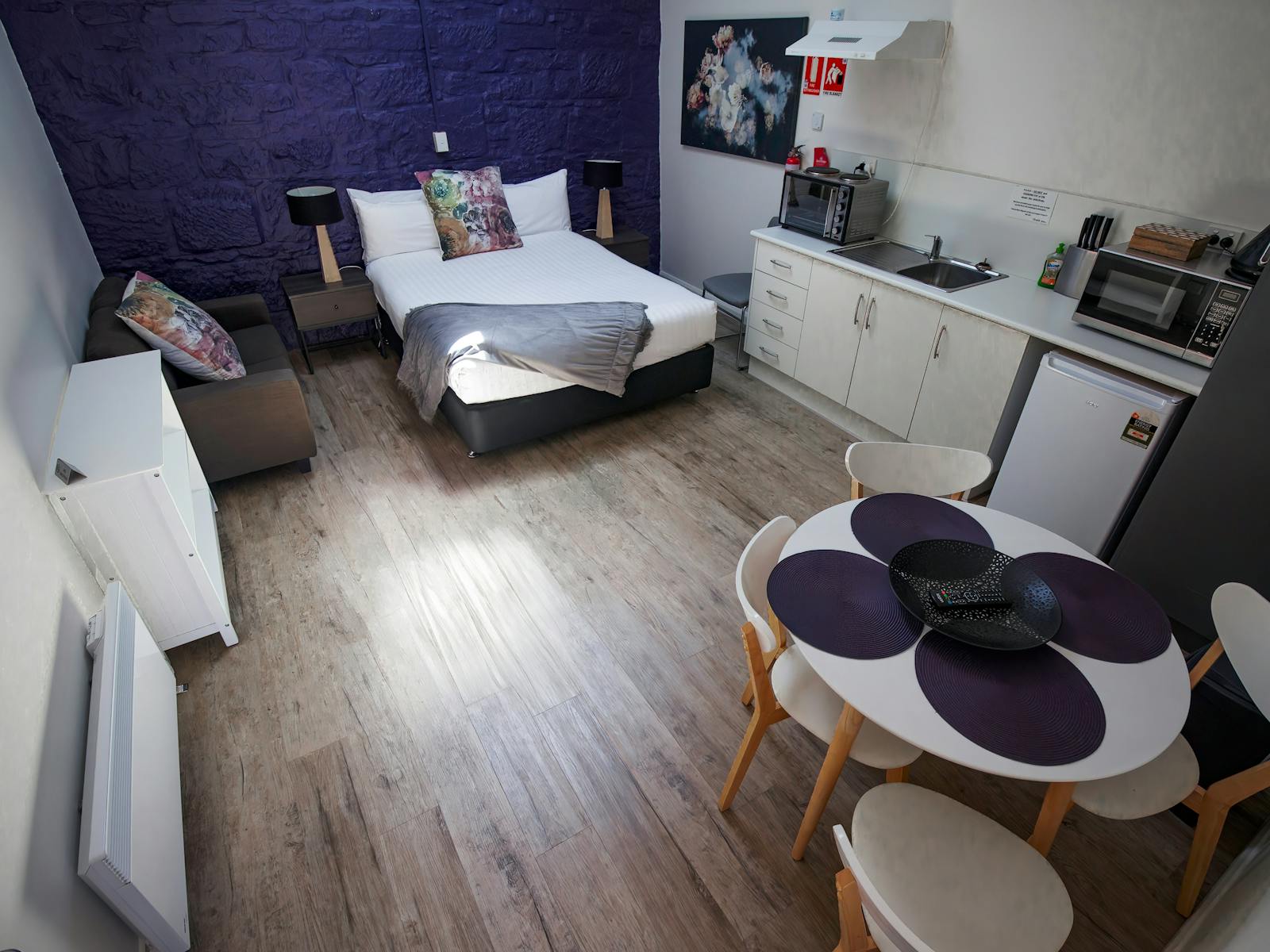 picture showing the interior of the self contained rooms with bed , kitchenette and dining table