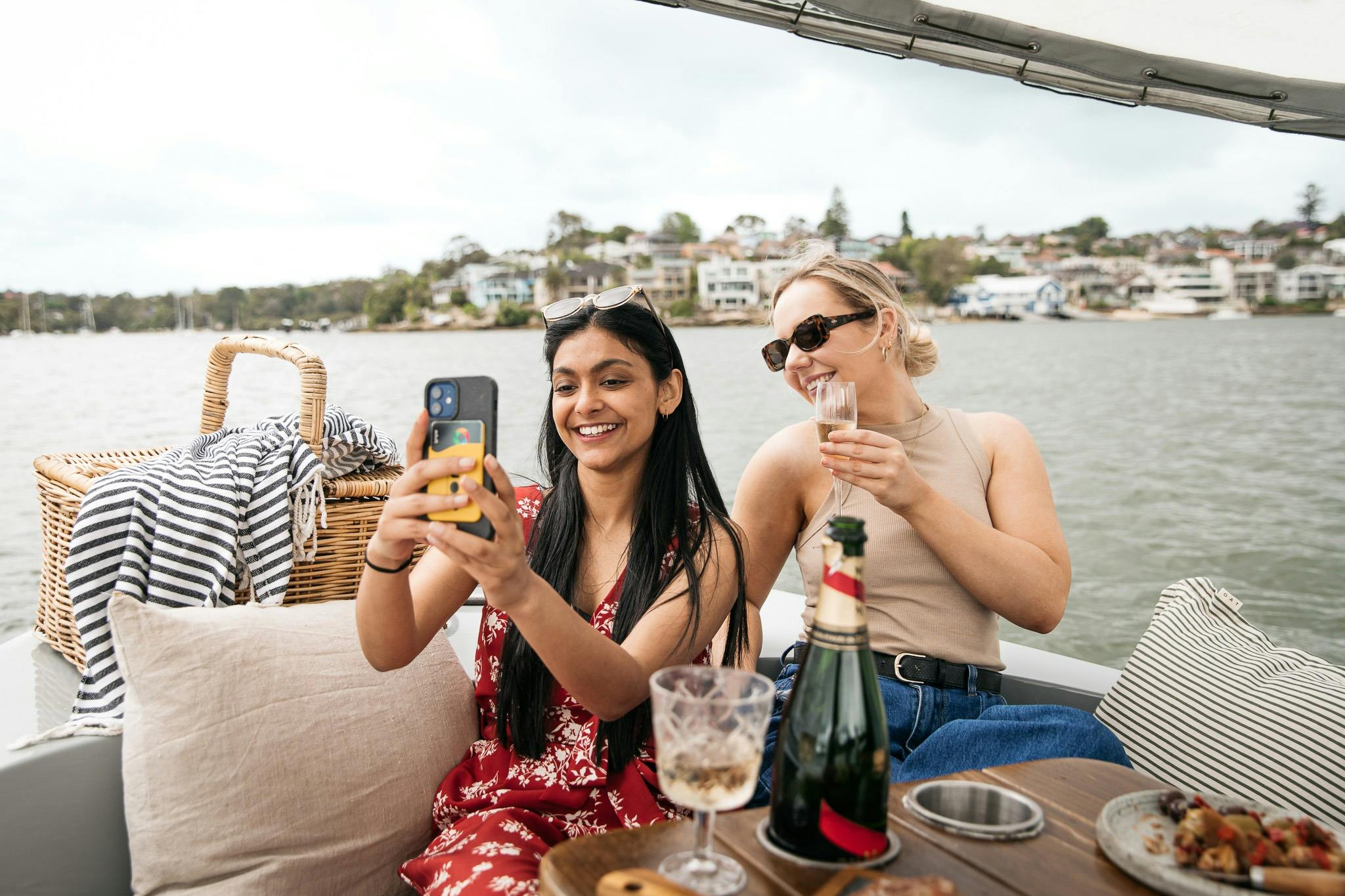 Two women take a selfie on a GoBoat