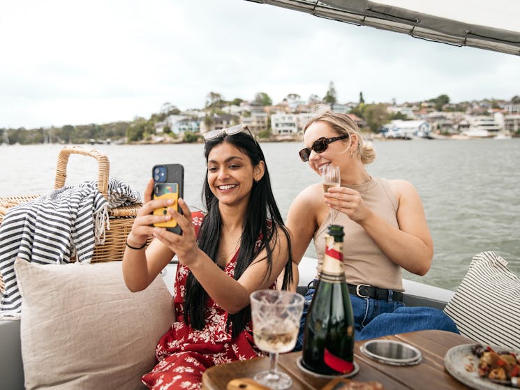 Two women take a selfie on a GoBoat