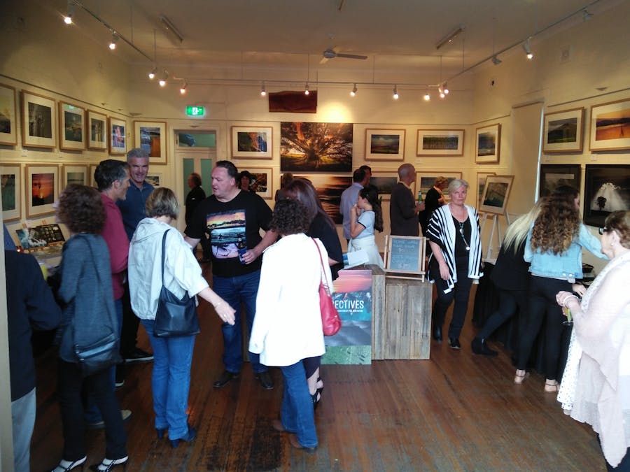 Photgraphy exhibition inside the Old Fire Station, people viewing photographs