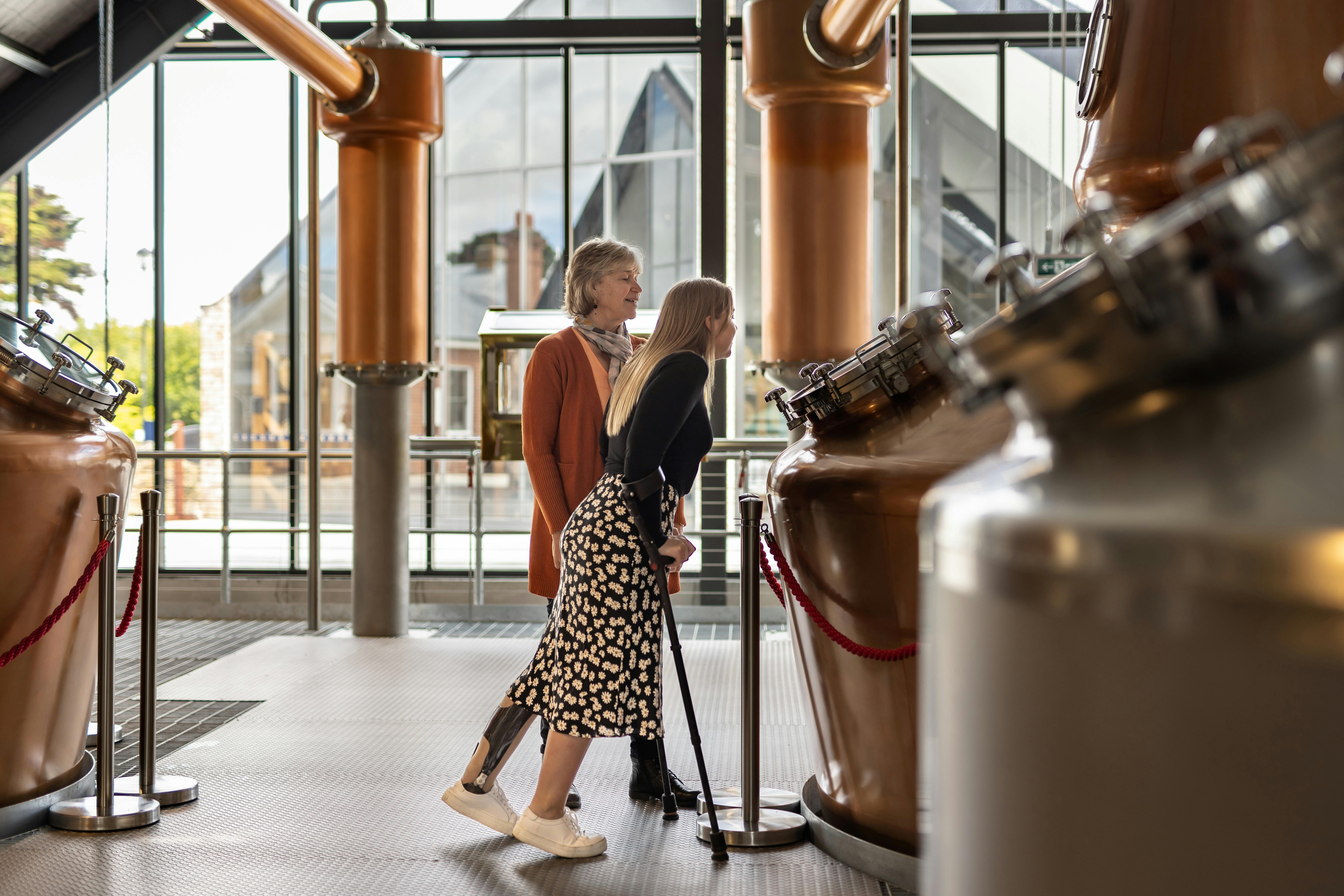Two women looking into a whisky still