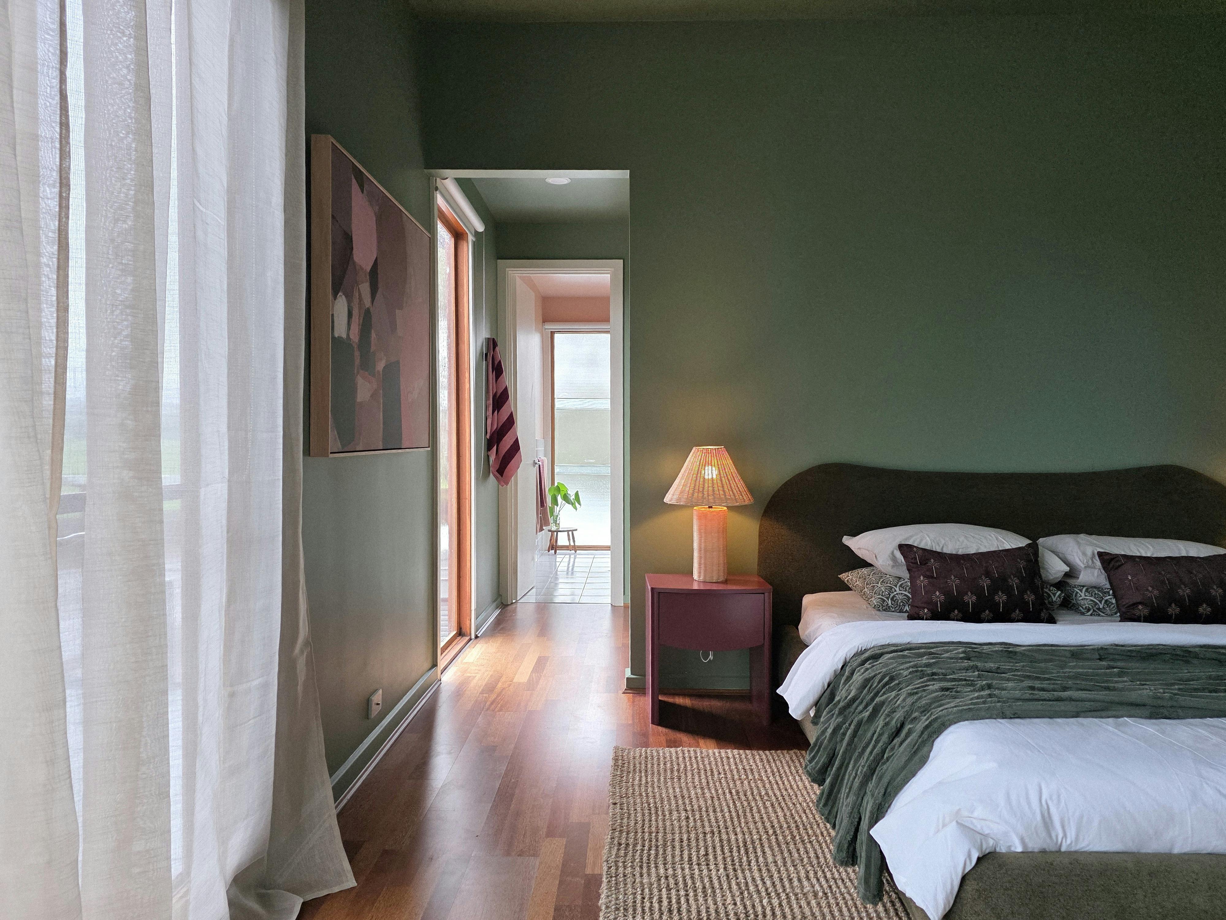 A light-filled view from the king bedroom into the sunset-hued ensuite at Villa 1 by The Shores