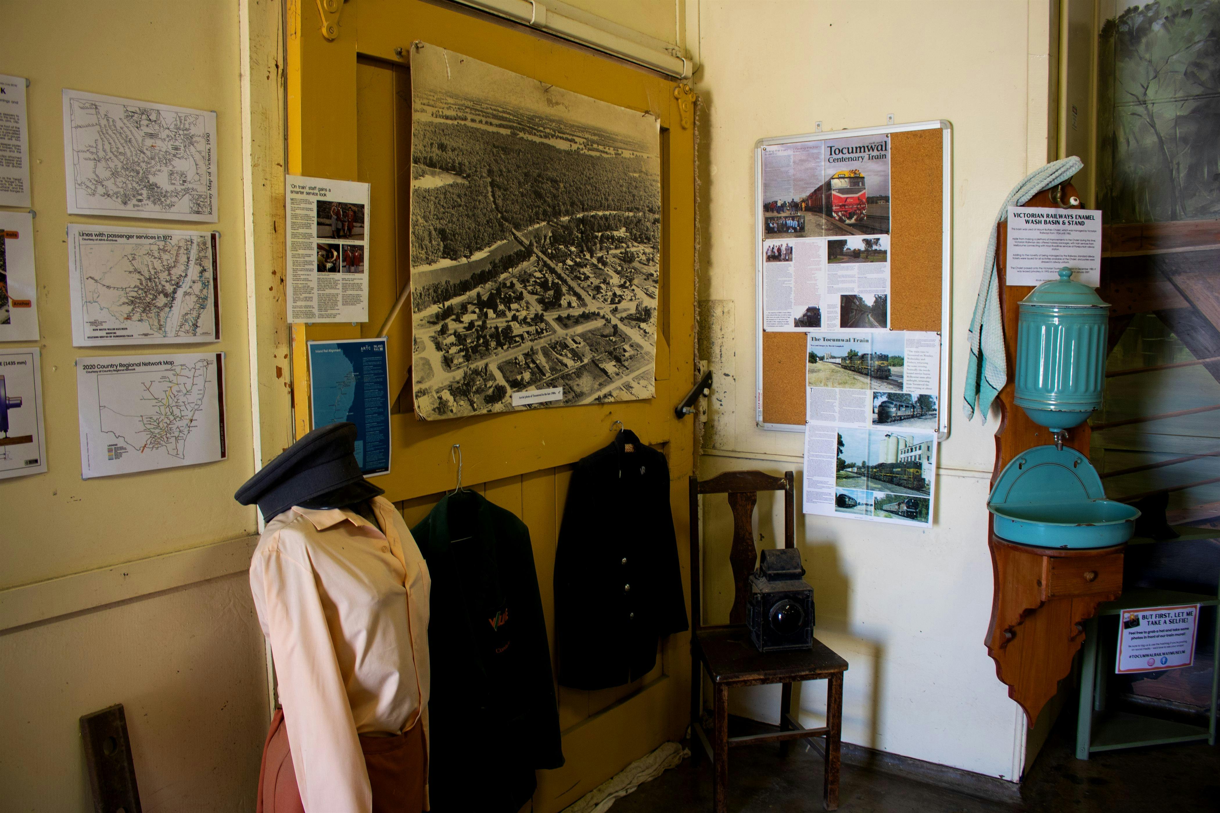 Museum interior, featuring display of railway uniforms, and photos and articles on the  walls