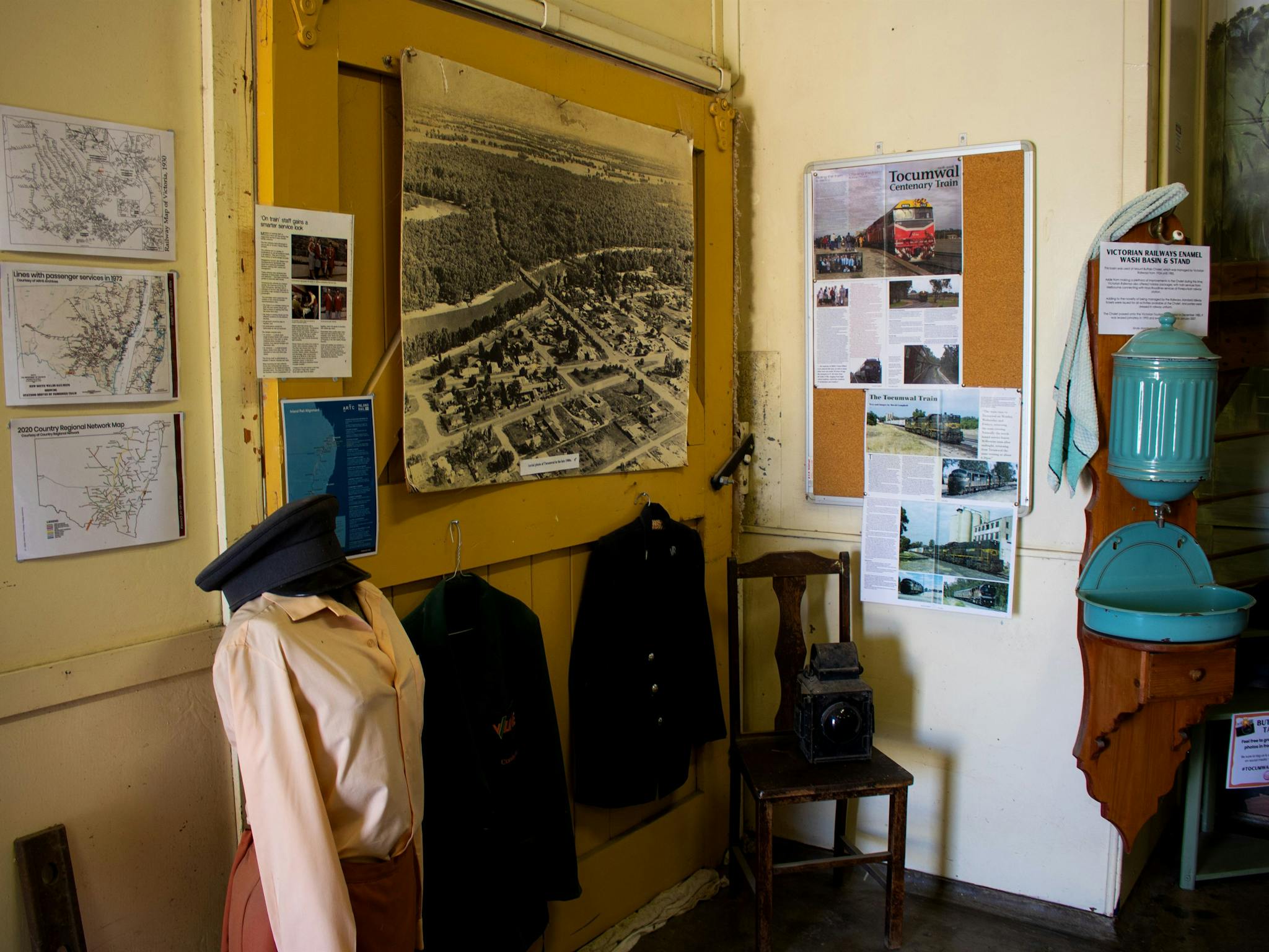 Museum interior, featuring display of railway uniforms, and photos and articles on the  walls