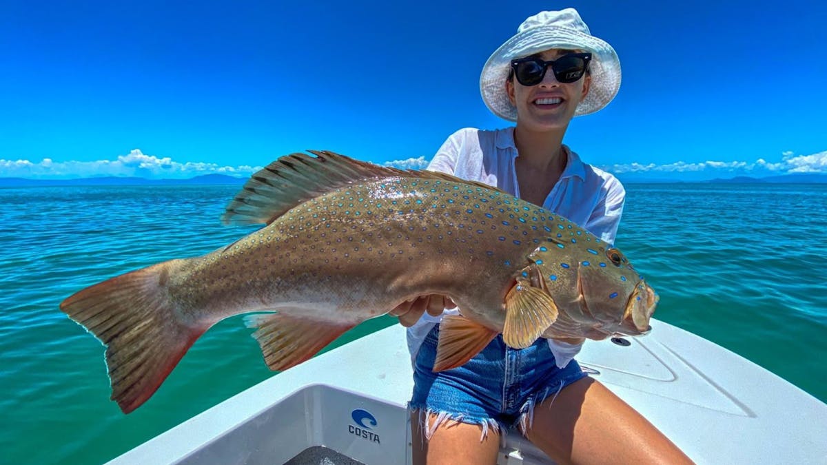 Woman holding fish catch