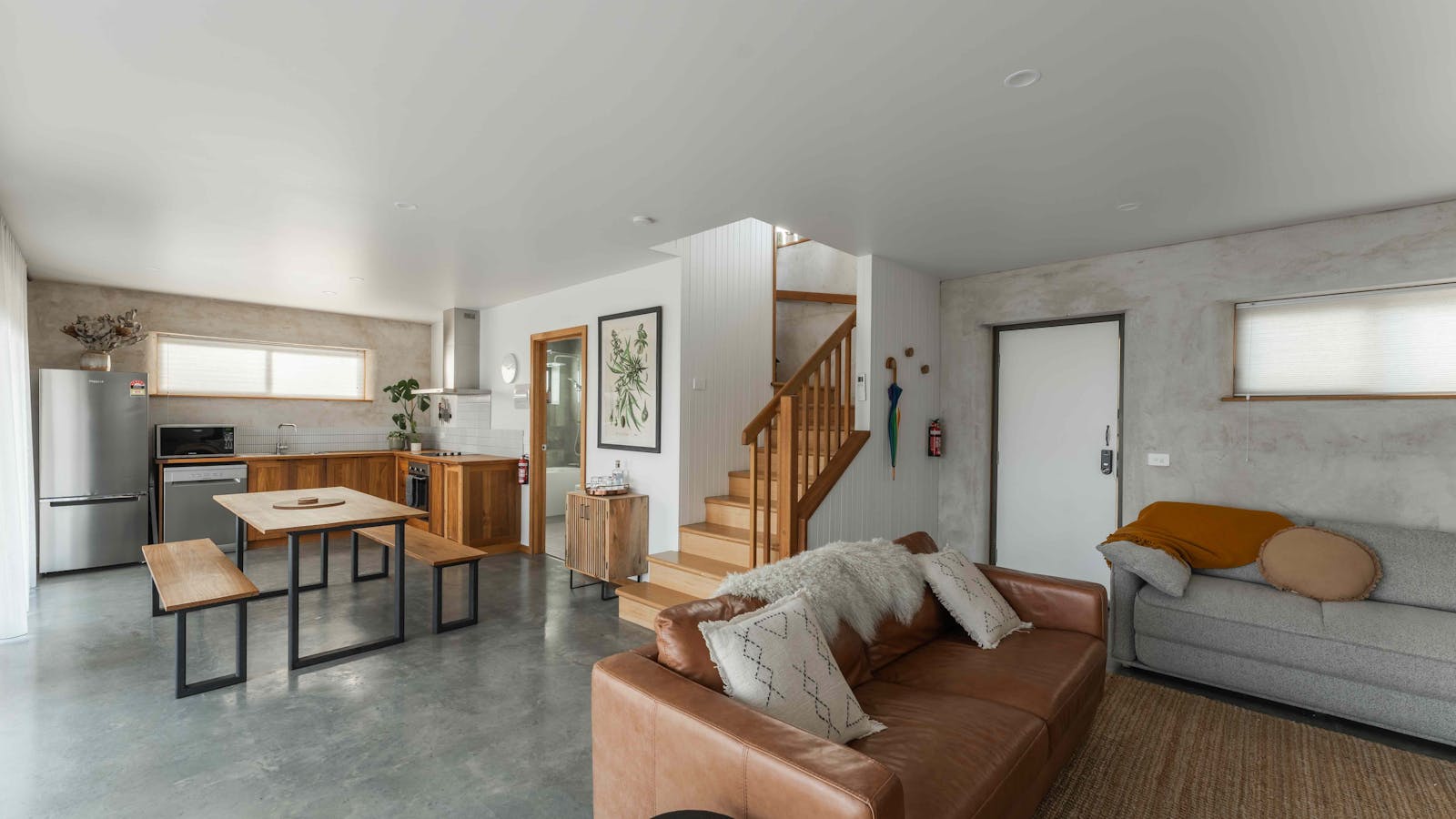 A comfortable and relaxed living and dining area on the ground floor with doors opening to patio.