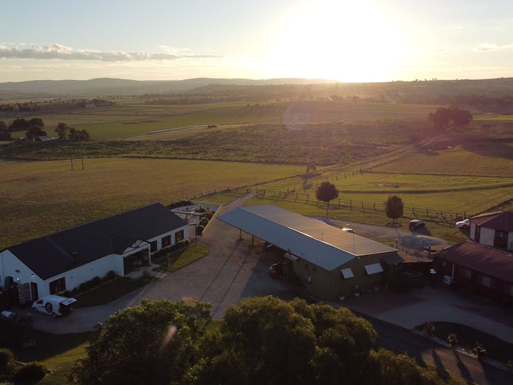 Sunset at our farm; in view is the function centre, bunkhouse, train and yurt accommodation options.