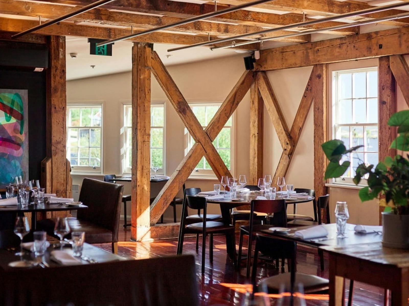 Picture of tables and chairs with exposed beams, features of the old flour mill - Ritchies Mill