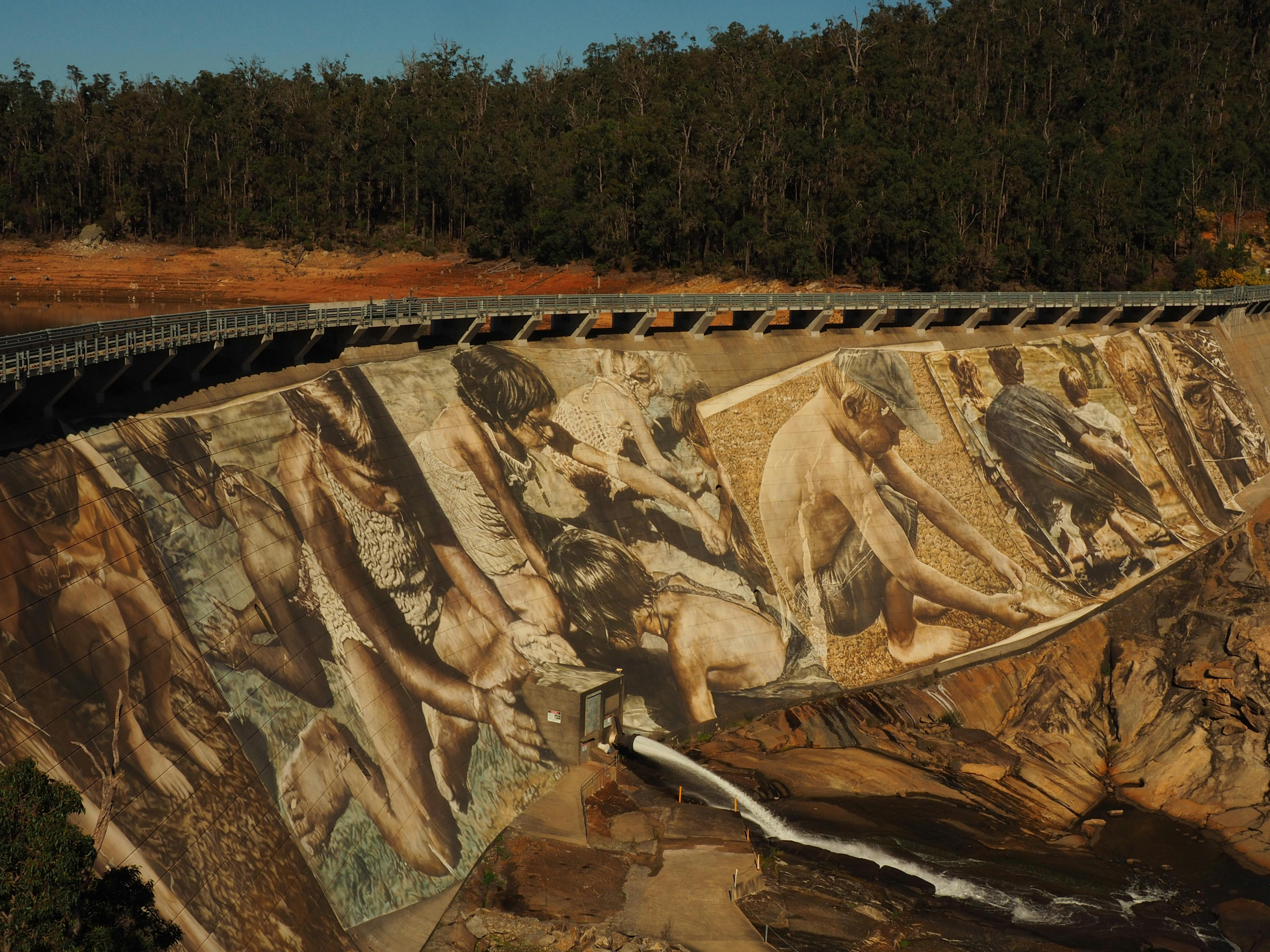 Enlarged photographs painted on dam wall