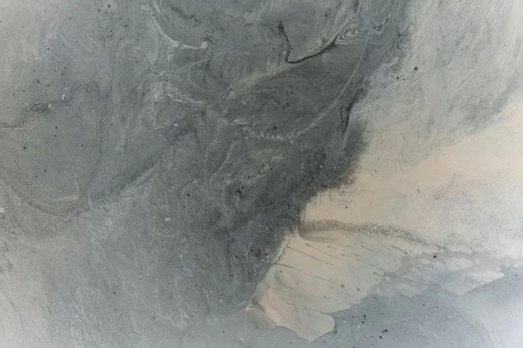 A mix of grey, beige and white paint melding in an abstract pattern