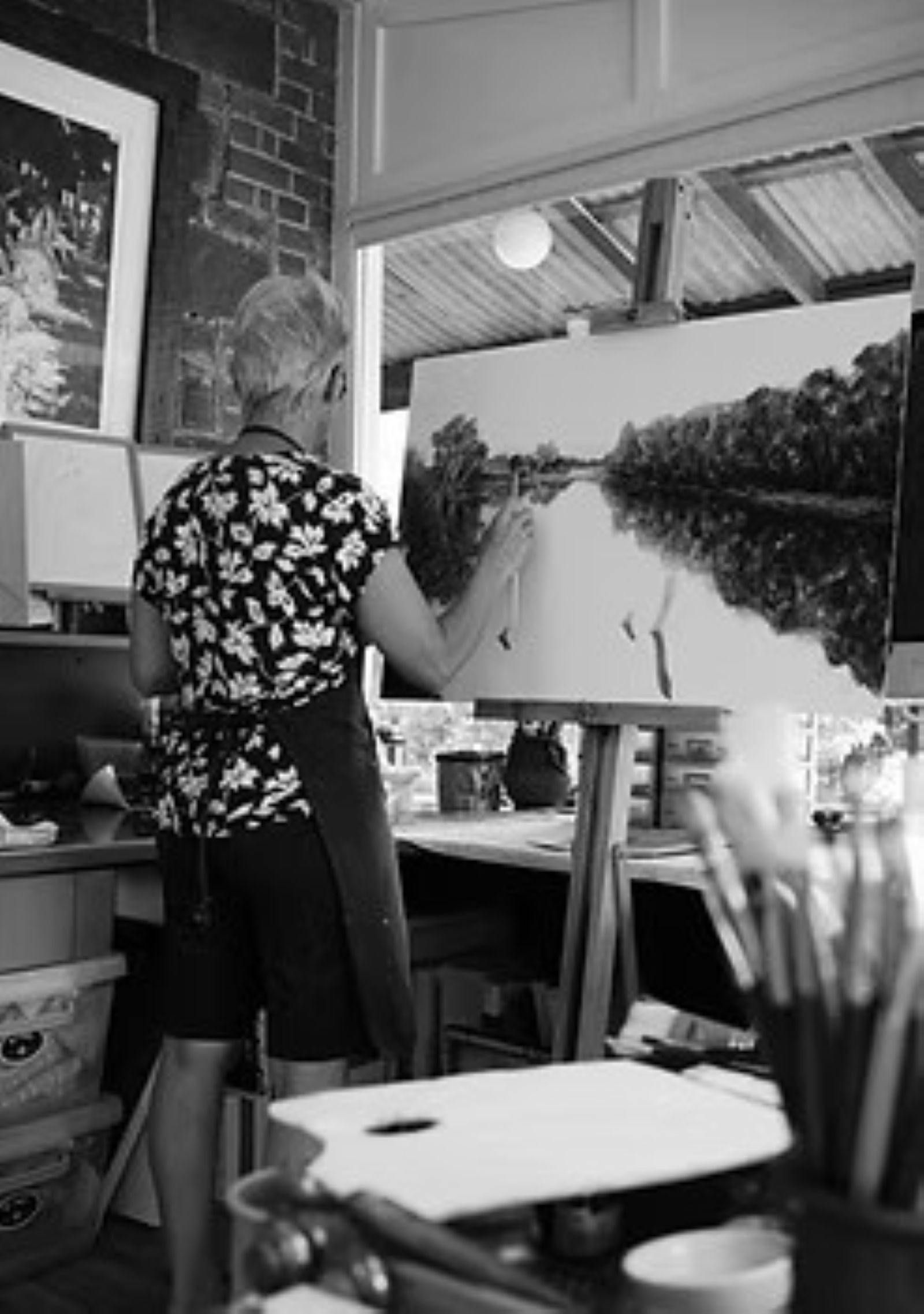 Artist Therese Crowe painting in her studio