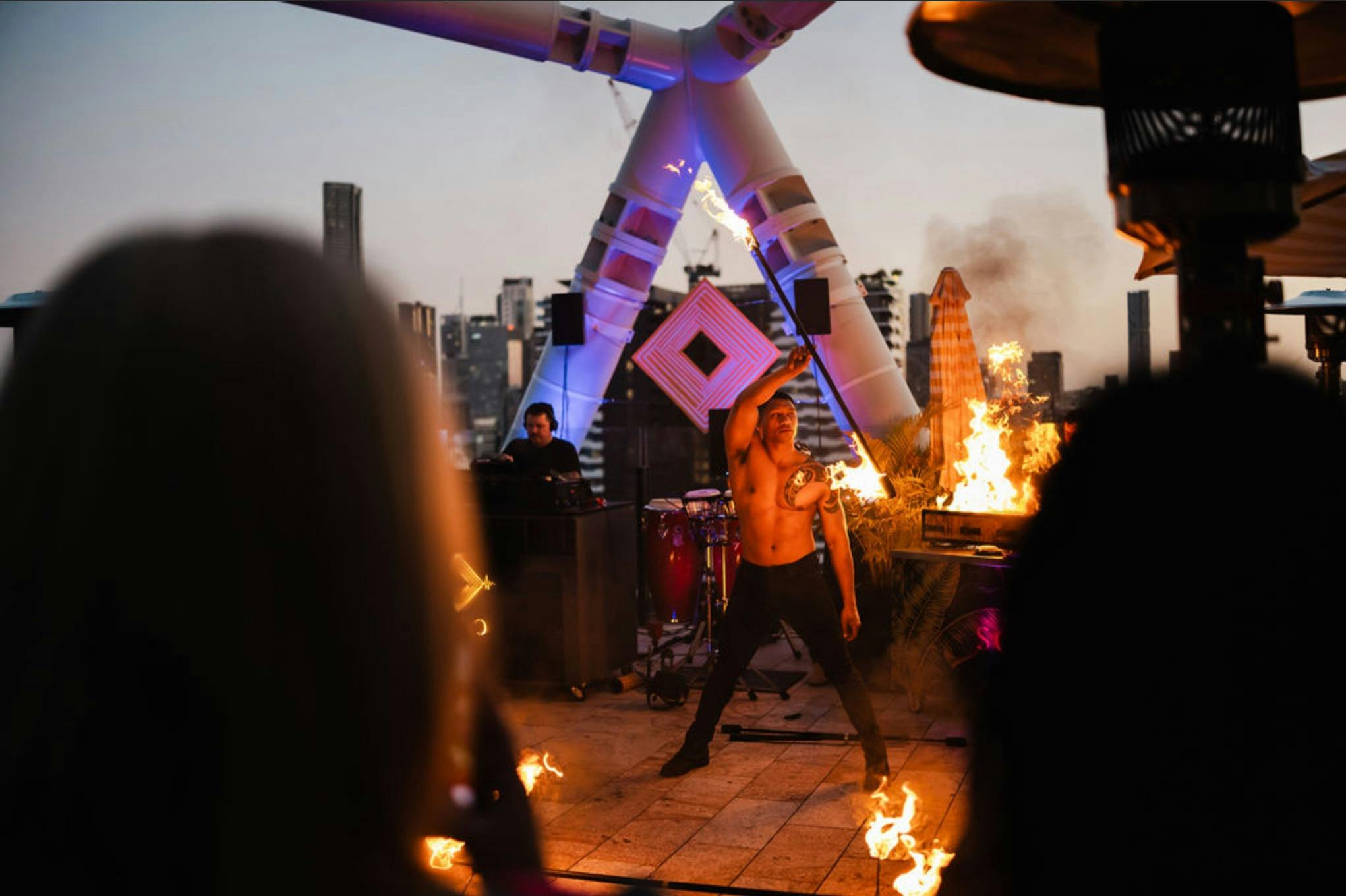 A male fire dancer on Soko Rooftop
