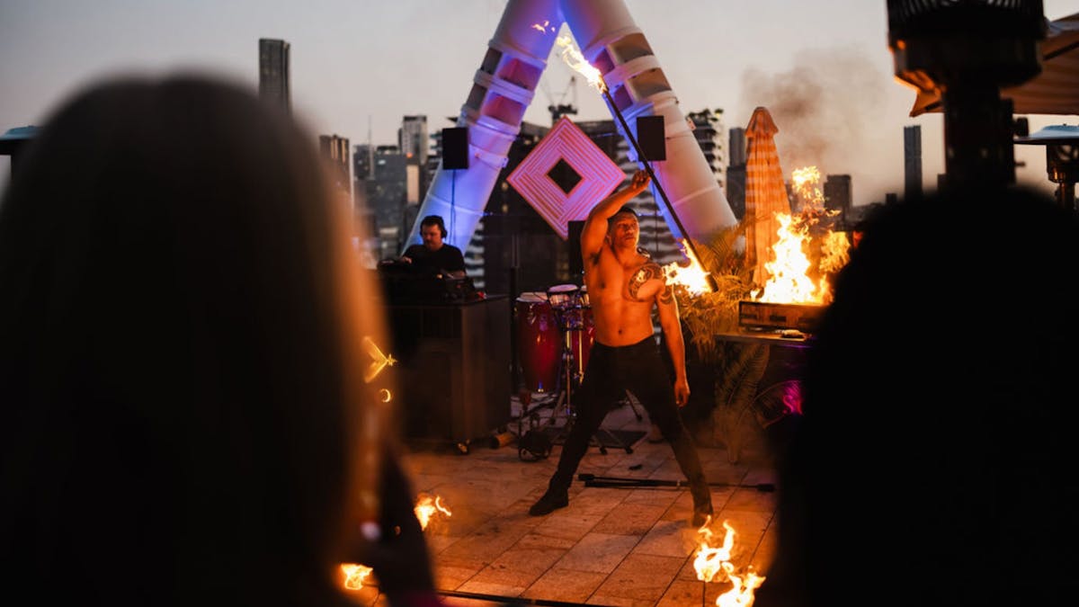 A male fire dancer on Soko Rooftop