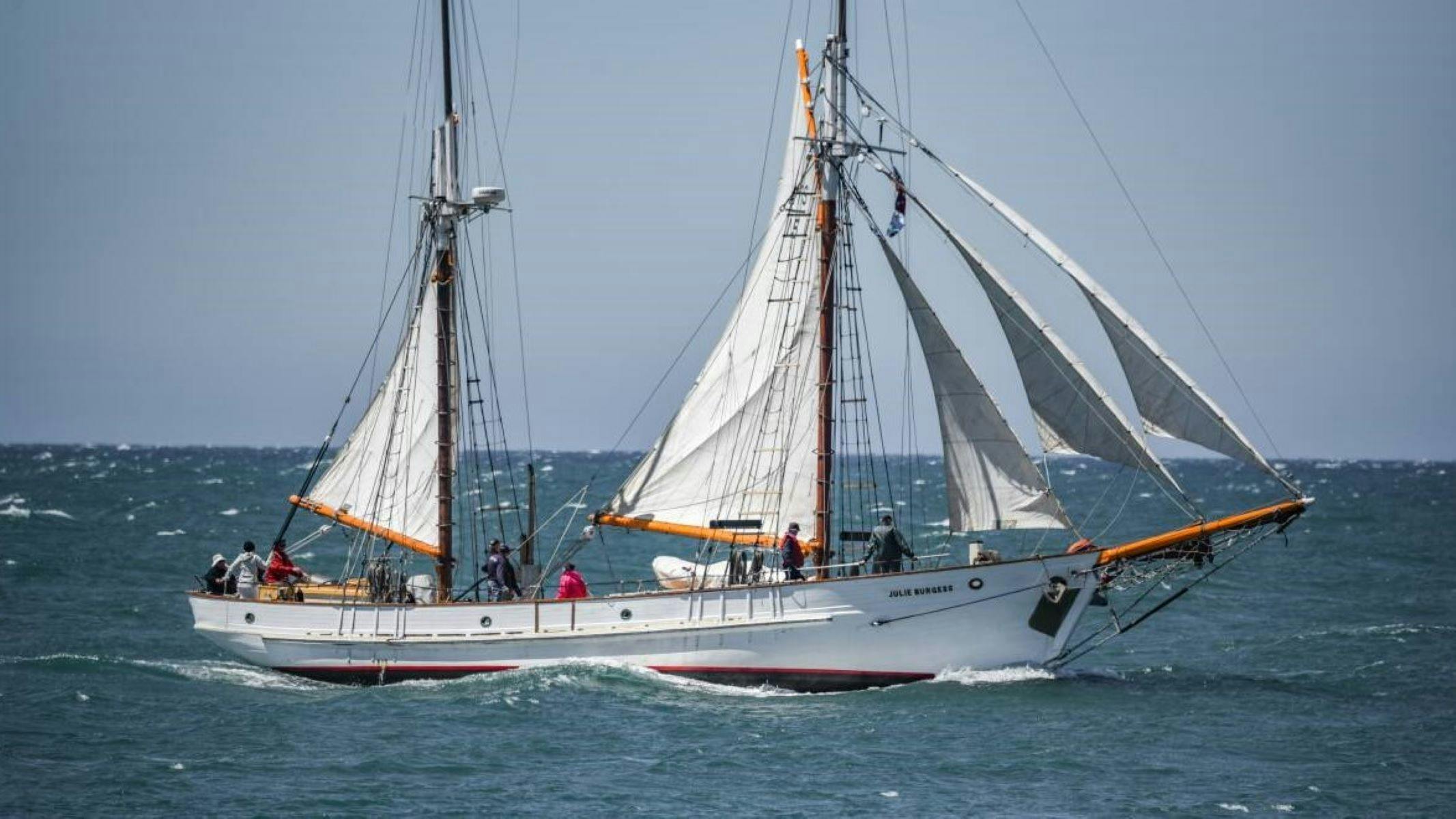 Julie Burgess Tall ship on the ocean with sails blowing in wind