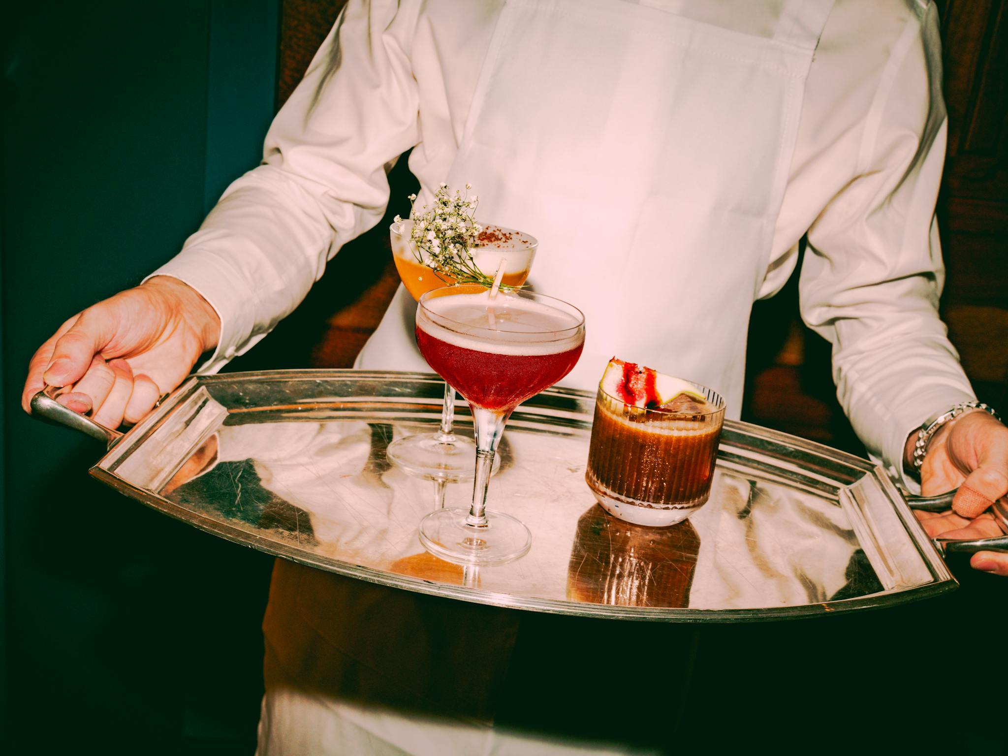 A silver tray with two lovely cocktails on it A silver tray with two lovely cocktails on it