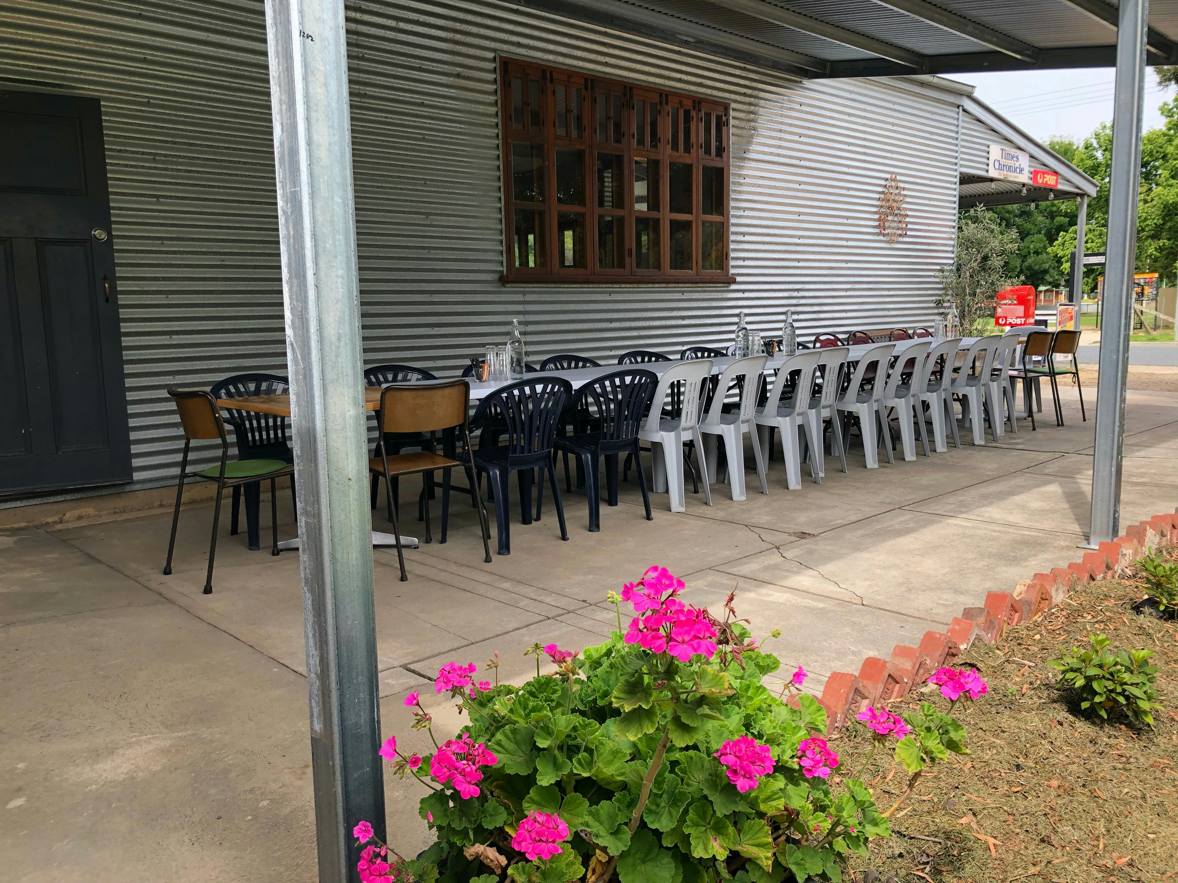 Long table and chairs beside cafe.