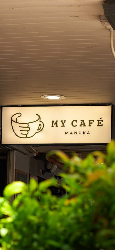Backlit sign saying 'My Cafe Manuka'