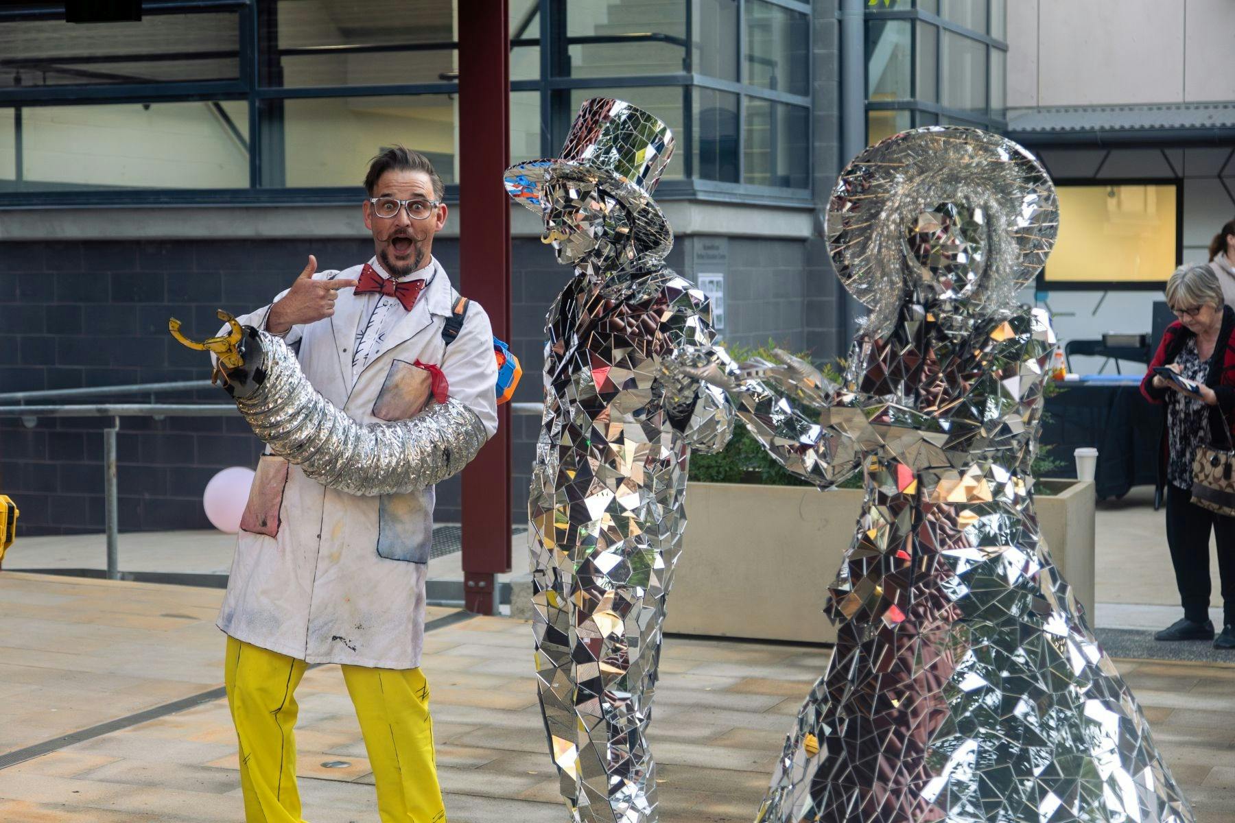 Children's entertainer Pretty Amazing Jono standing next to performers Mirror Man and Mirror Lady