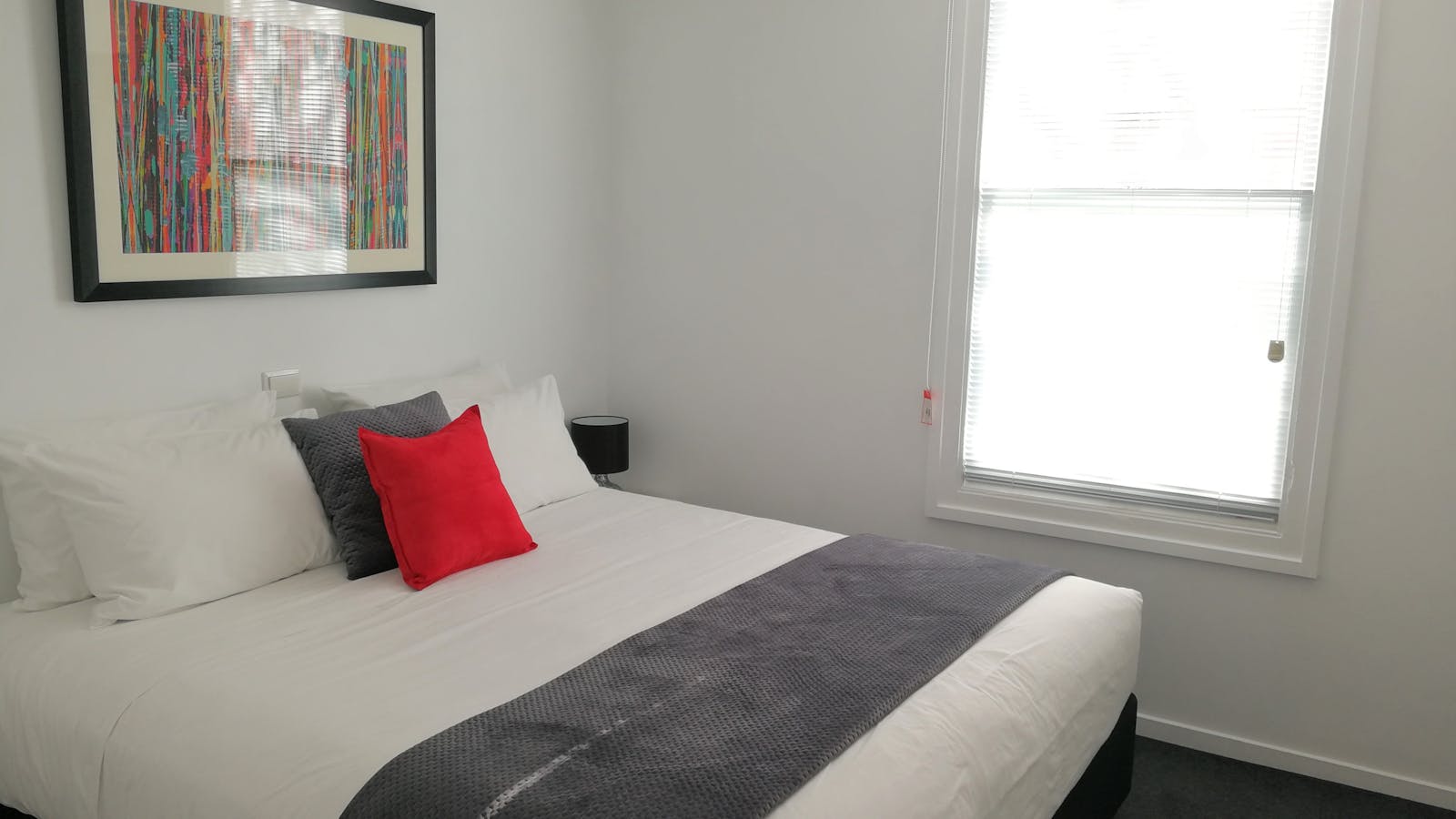 Second bedroom configuration: king bed (shown) or two single beds.