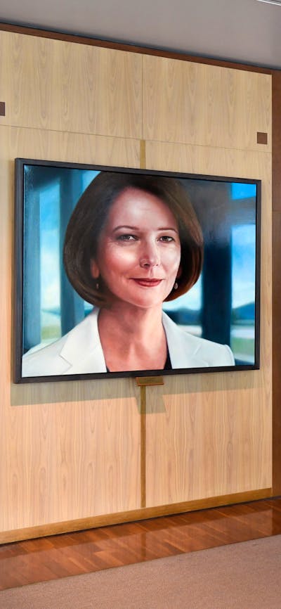 A person showing a portrait to a family of three