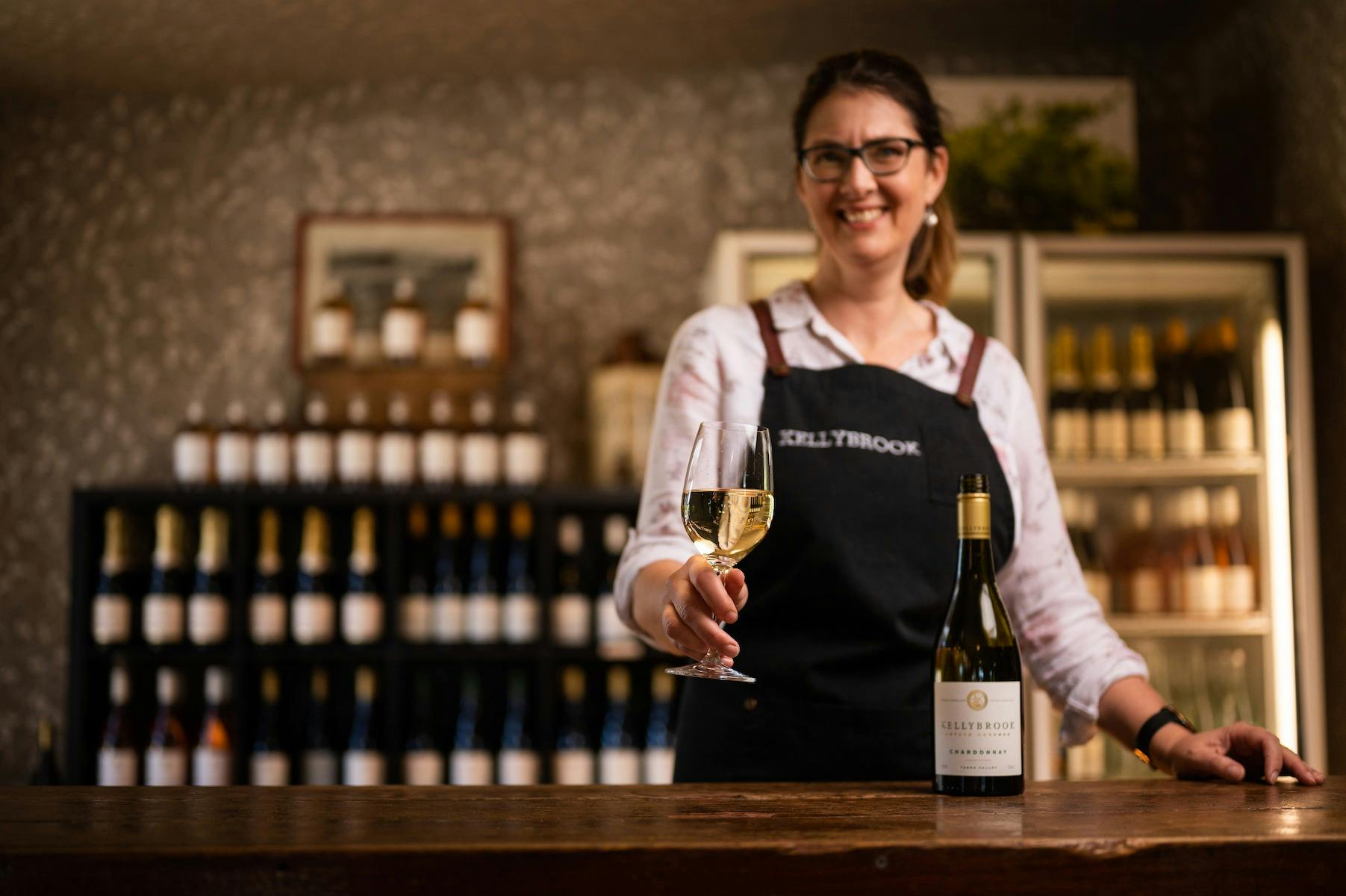 Cellar door staff serving Chardonnay