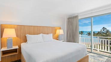 Ocean Side King Room at Airlie Beach Hotel with a king bed, modern furnishings, and balcony