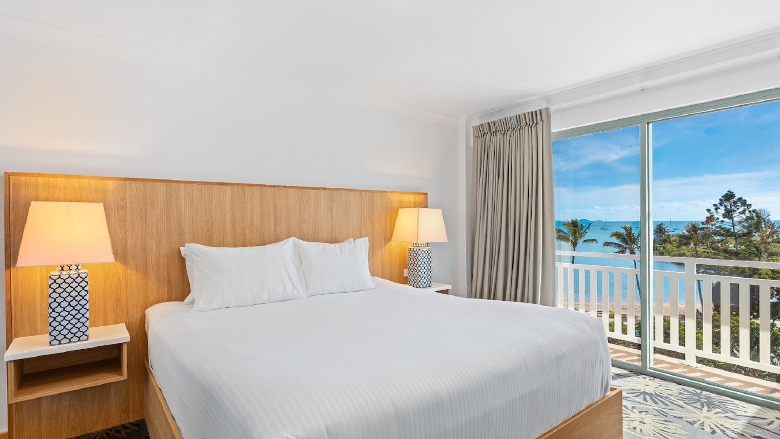 Ocean Side King Room at Airlie Beach Hotel with a king bed, modern furnishings, and balcony Ocean Side King Room at Airlie Beach Hotel with a king bed, modern furnishings, and balcony