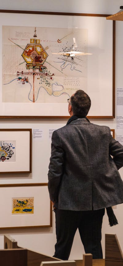 Man looking at Taglietti architectural sketches