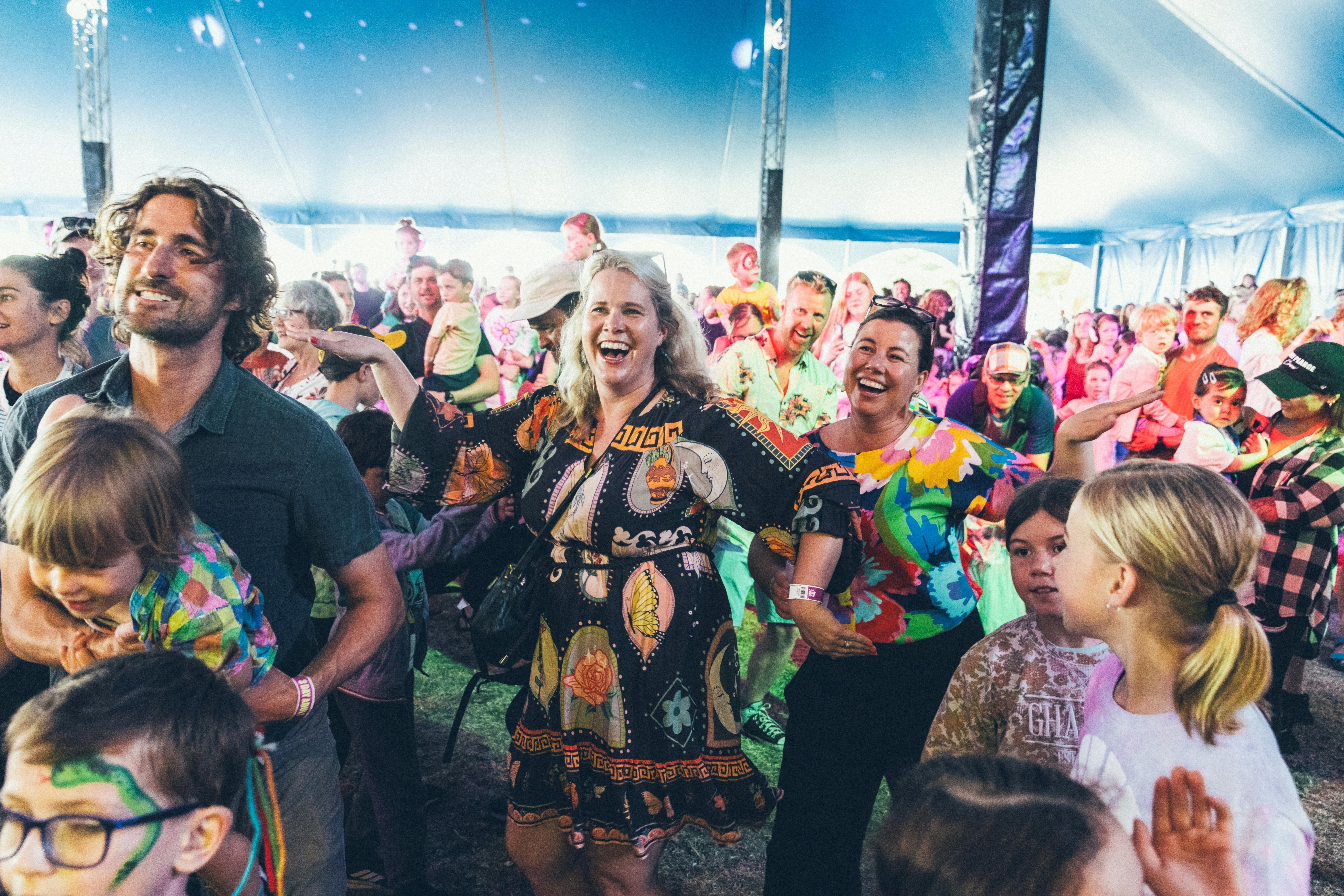 Smiling festival goers dancing to the music